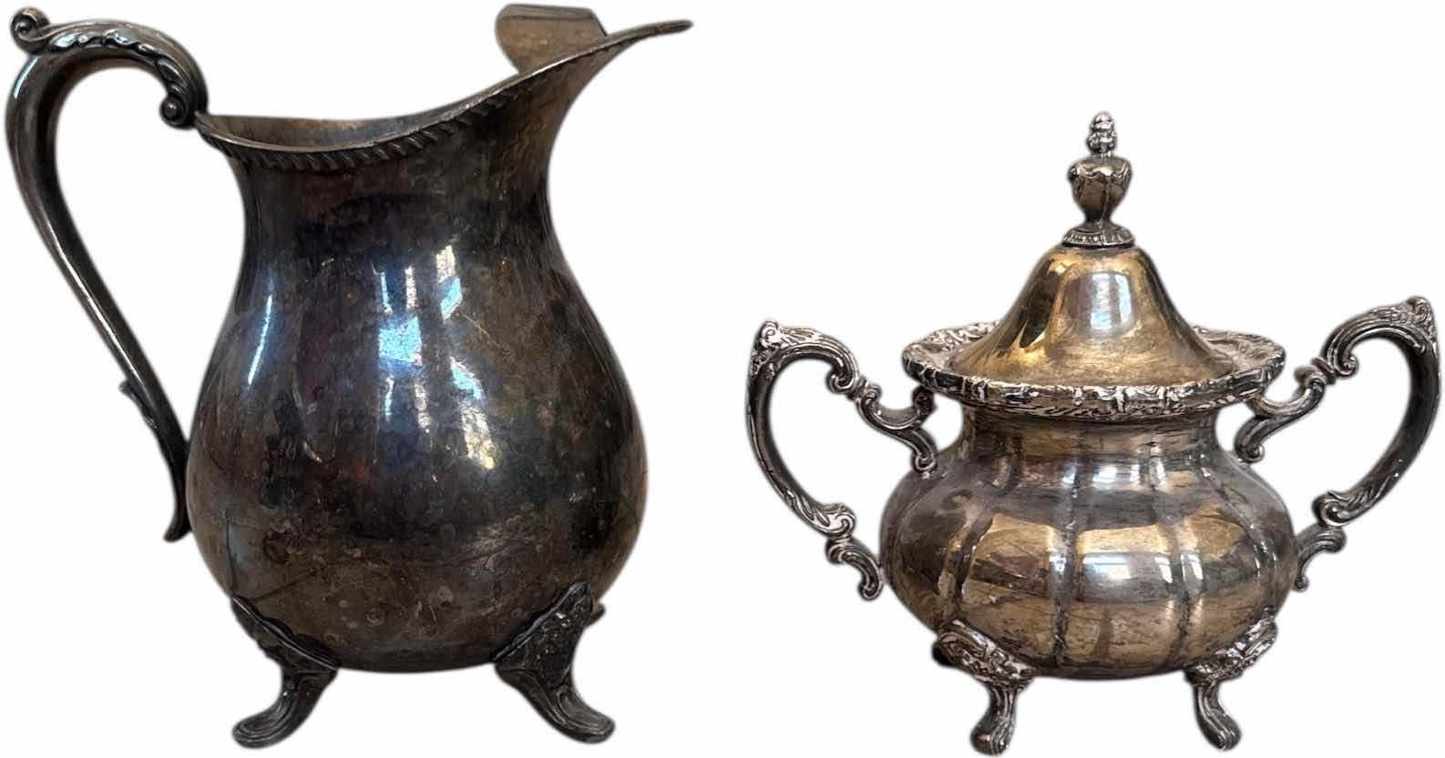 Photo 1 of 2- ANTIQUE SILVER PLATED WATER PITCHER AND SHEFFIELD SUGAR BOWL WITH LID

H8.25” AND SMALLER