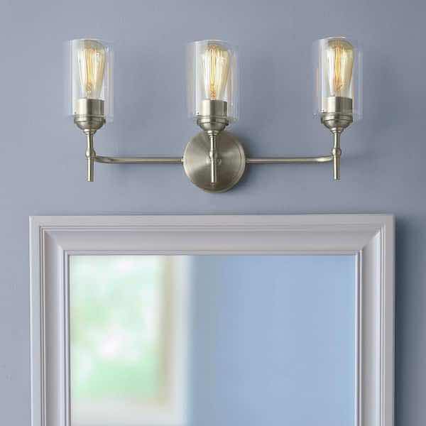 Photo 1 of HOME DECORATORS COLLECTION AYELEN BRUSHED NICKEL FINISH 3-LIGHT VANITY FIXTURE W CLEAR GLASS SHADE MODEL 39109-HBU 22” X 6” H10.25”