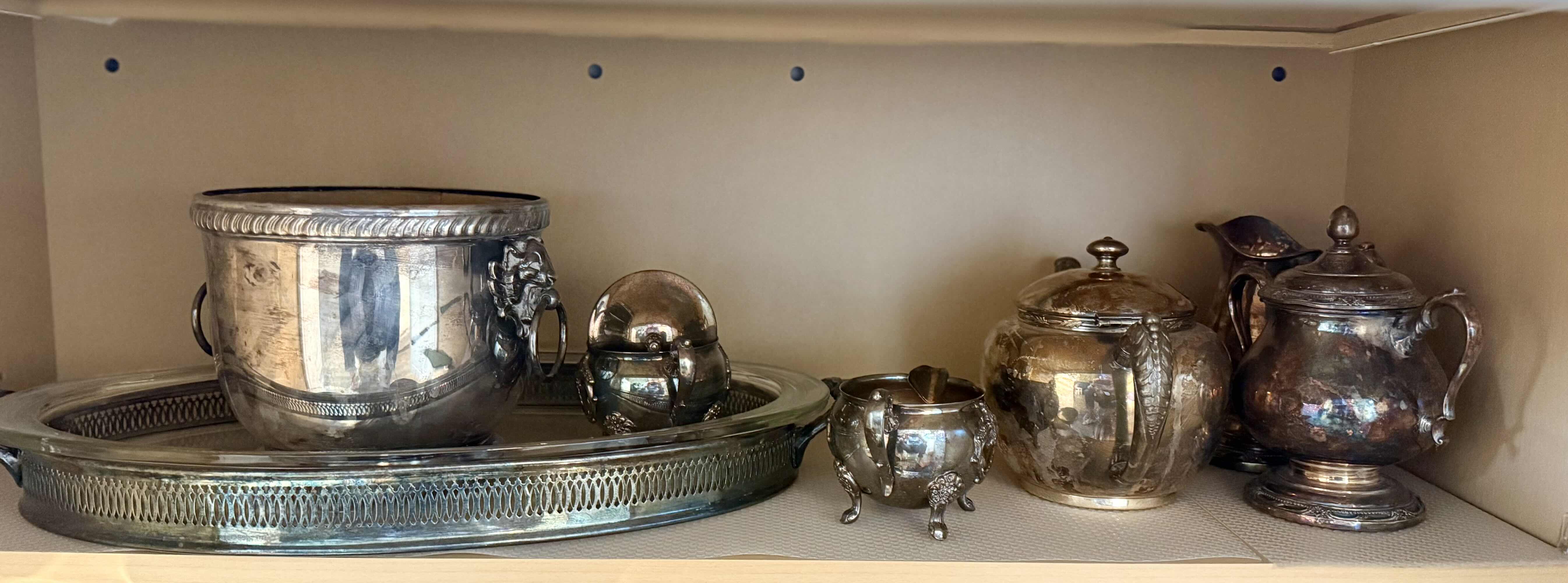Photo 1 of CONTENTS OF KITCHEN CABINET-SILVER-PLATED SERVE-WARE
