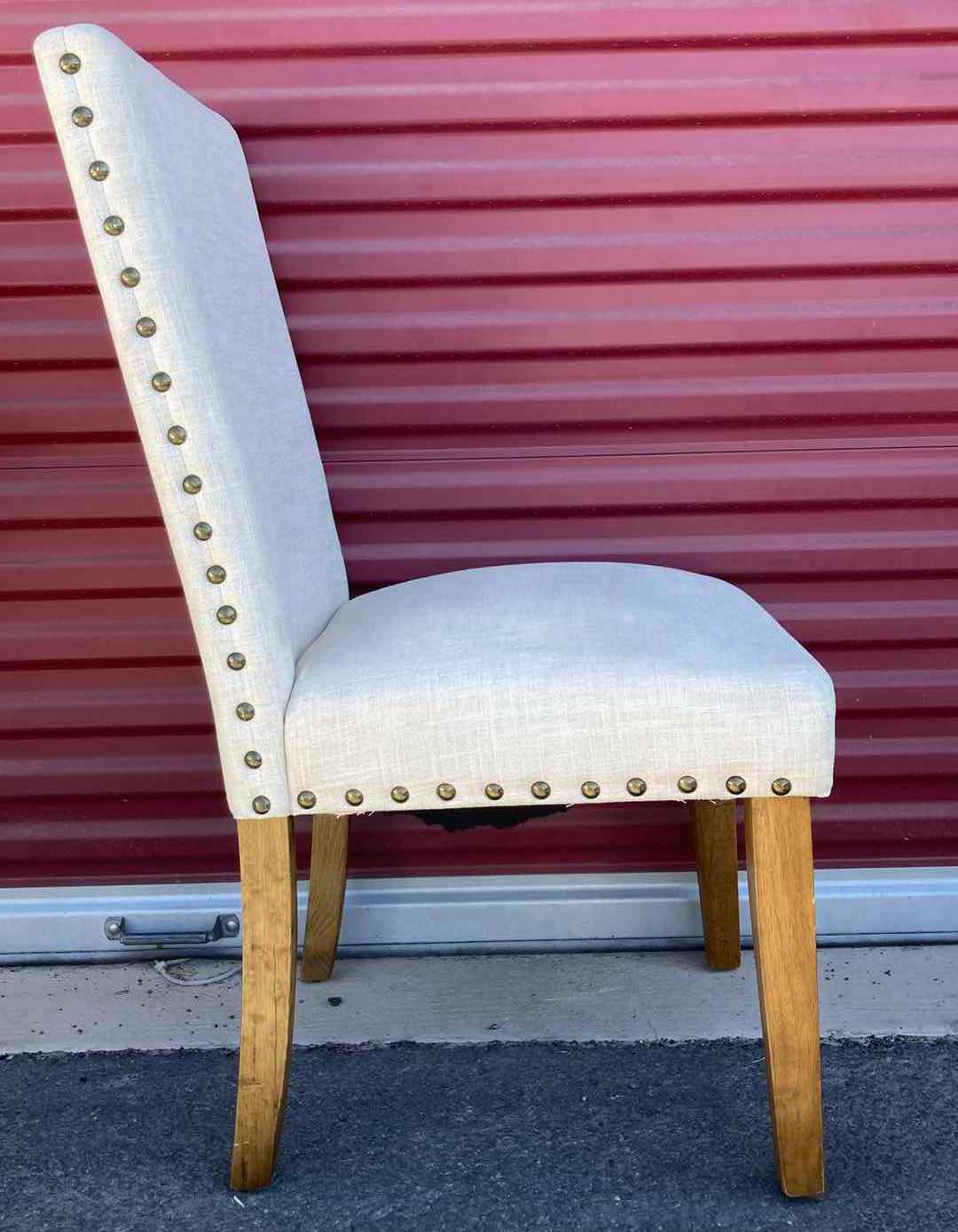Photo 1 of BEIGE UPHOLSTERY ARMLESS DINING CHAIR W NAILHEAD TRIM AND RUBBERWOOD LEGS 19” X 20” H38.5”