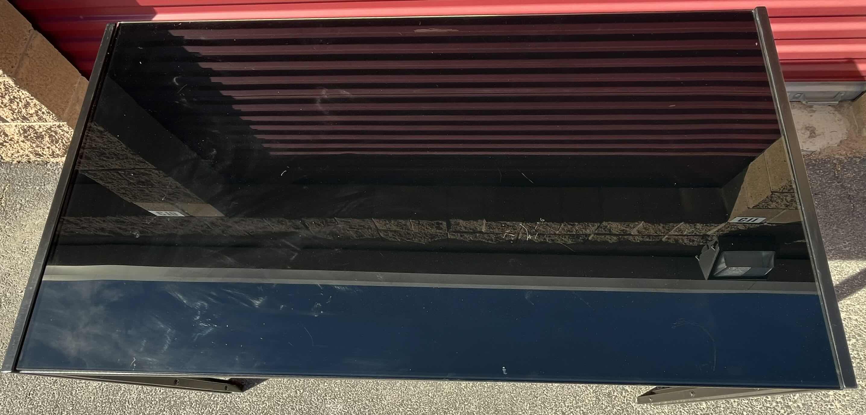 Photo 1 of BLACK FINISH GLASS TOP METAL FRAME TABLE 51.25” X 27.5” H29.75”