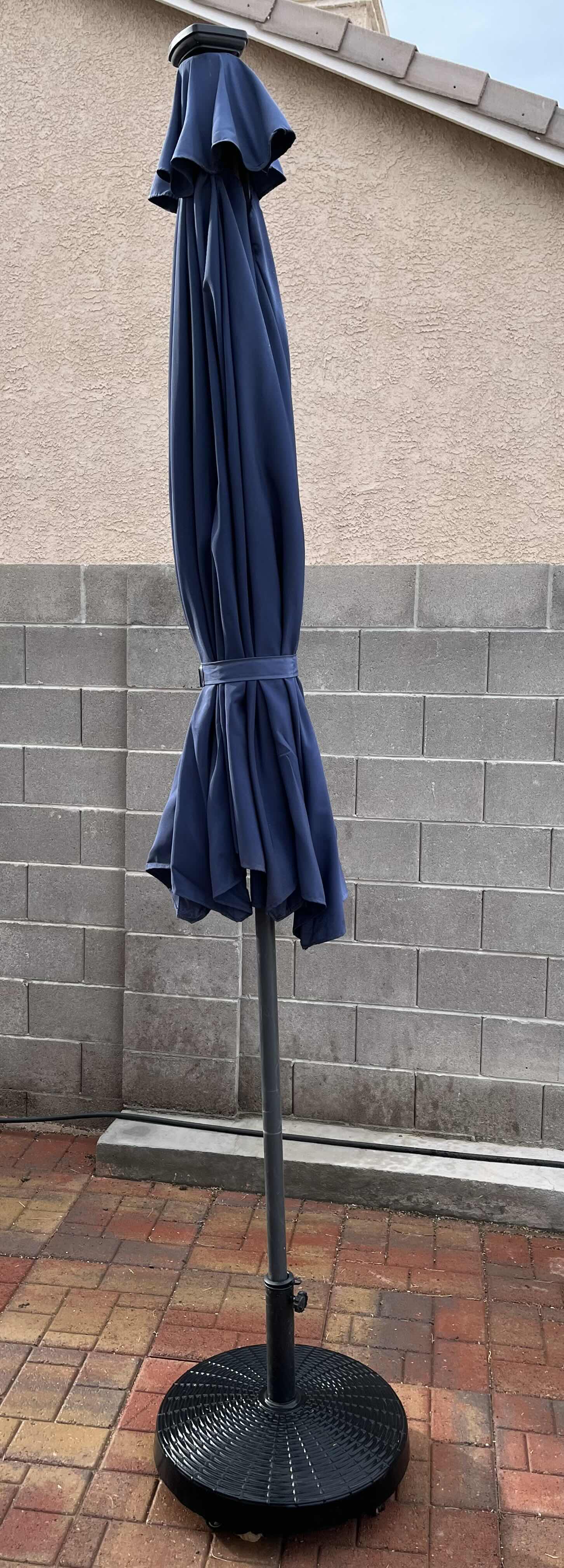 Photo 1 of DARK BLUE PATIO UMBRELLA W ROLLING UMBRELLA STAND 116” X 110”