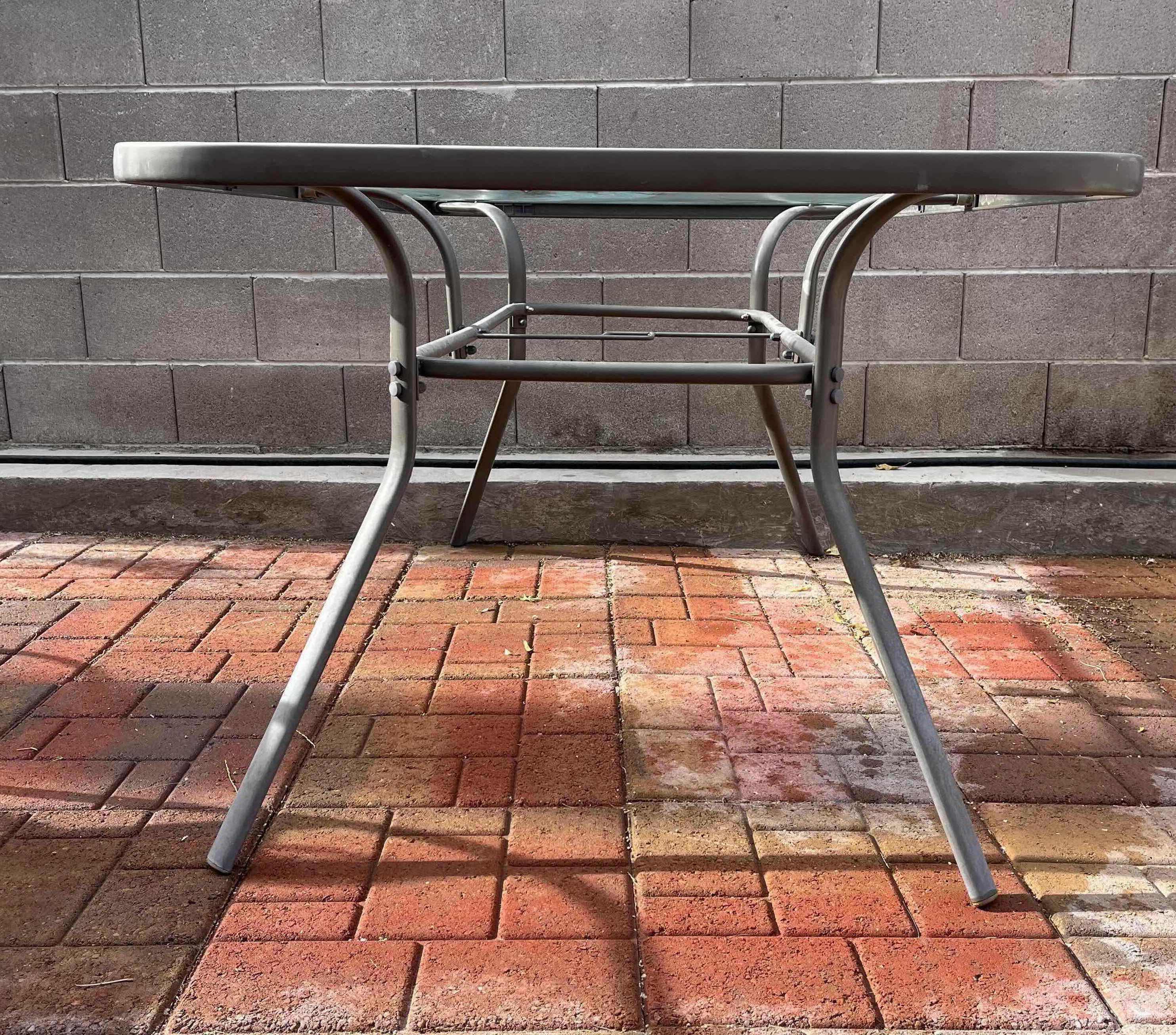 Photo 1 of PATIO GLASS TOP TABLE 60” X 38” H28.5” W MESH CHAIRS (6)