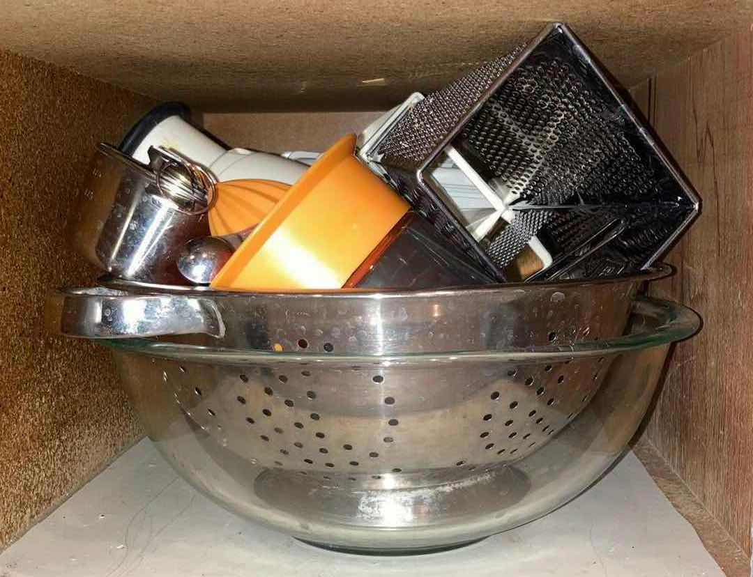 Photo 1 of CONTENTS OF CABINET- PLASTIC CUTTING BOARDS, BAKING PANS, STRAINERS, & KITCHEN ACCESSORIES