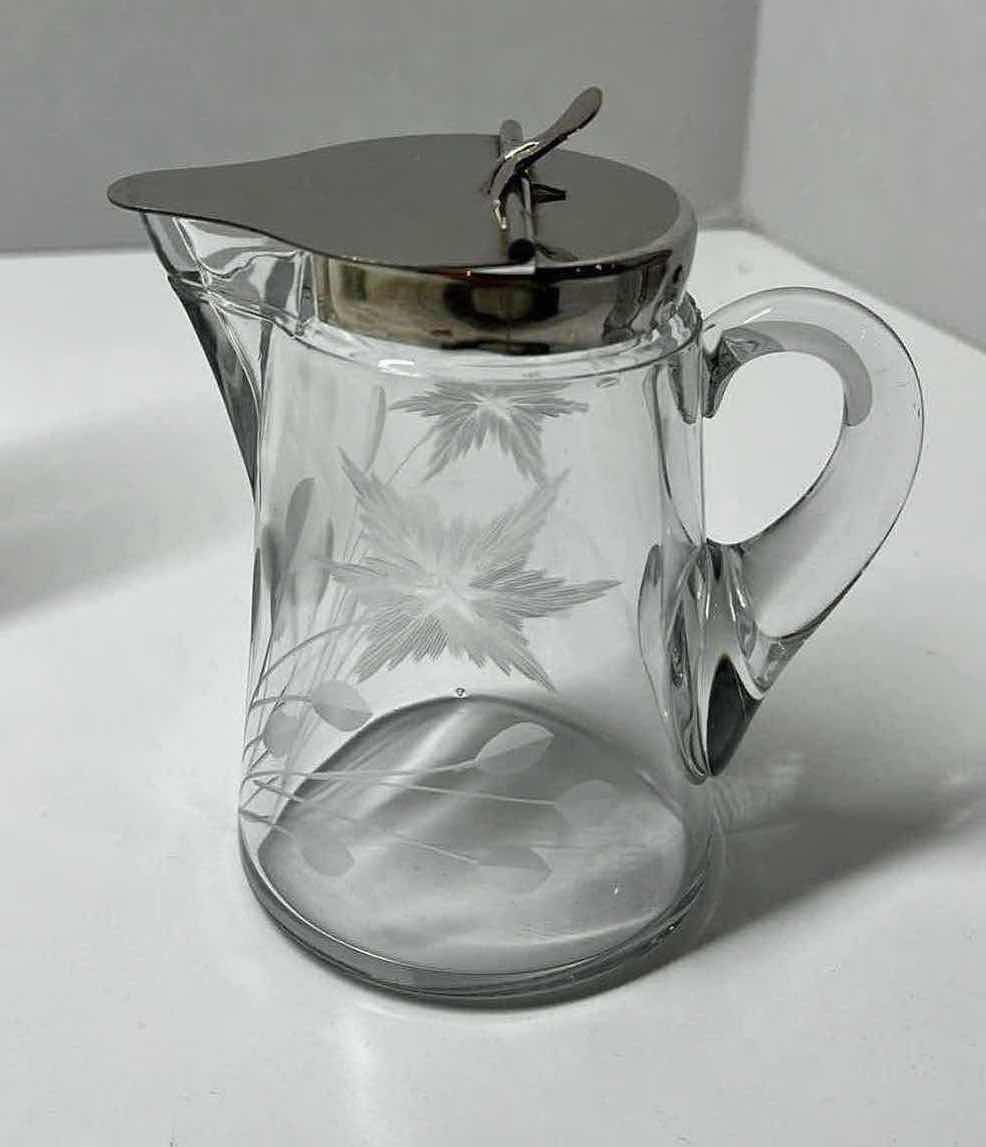 Photo 1 of ETCHED FLORAL DESIGN SYRUP DISPENSER W SPRING ACTION SILVER FINISH LID 4” X 3” H4.5”