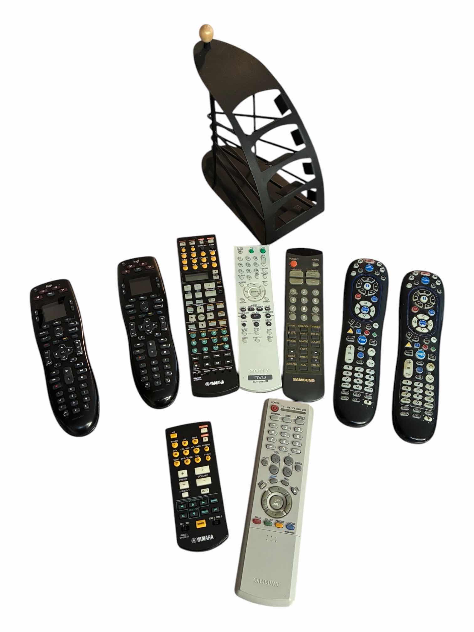 Photo 1 of LOGI HARMONY 665 UNIVERSAL REMOTES & VARIOUS BRAND REMOTES W BLACK METAL REMOTE CADDY
