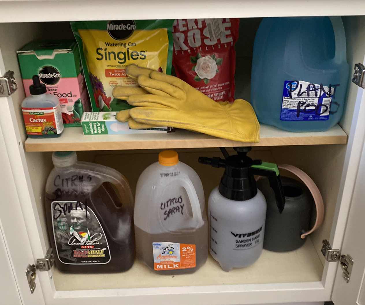 Photo 1 of CONTENTS KITCHEN CABINET PLANT FOOD AND WATERING CAN