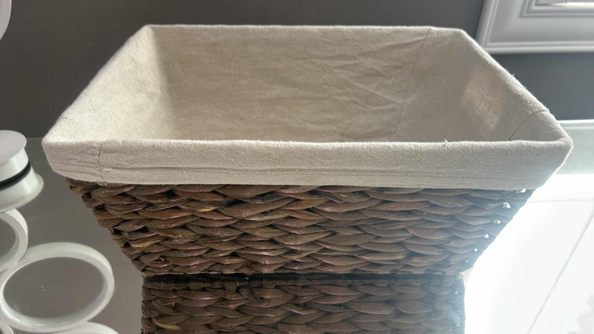 Photo 1 of FOUR WOVEN WICKER STORAGE BASKETS, THREE OF WHICH ARE COLLAPSIBLE.