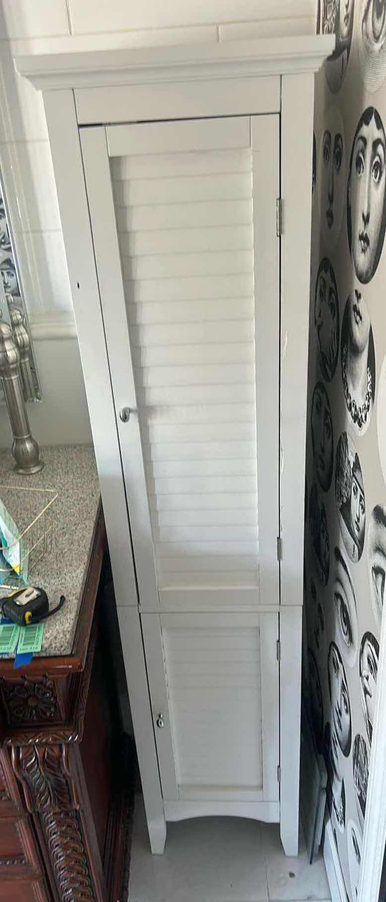 Photo 1 of WHITE, NARROW STORAGE CABINET. 12" X 13.5" X H. 63.25".