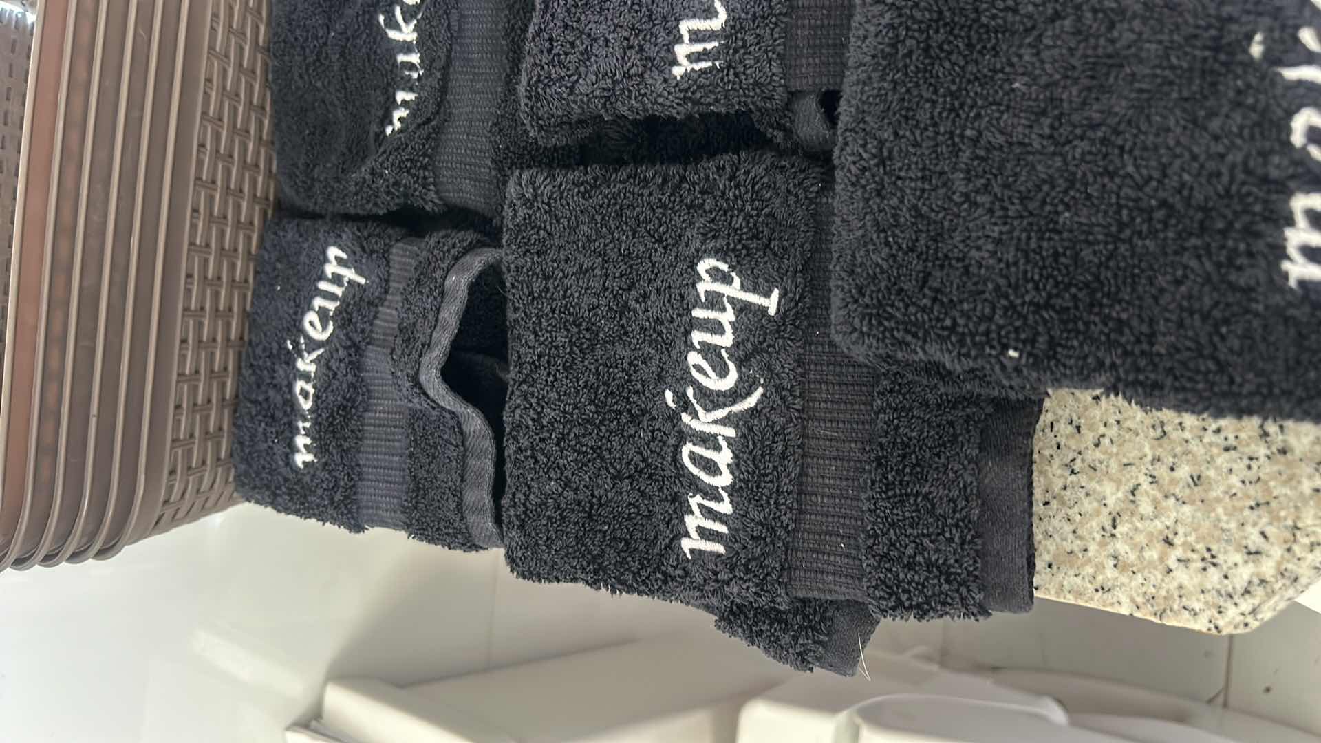 Photo 1 of SIX SMALL PLASTIC STORAGE BASKETS AND FIVE MAKEUP WASHCLOTHS.