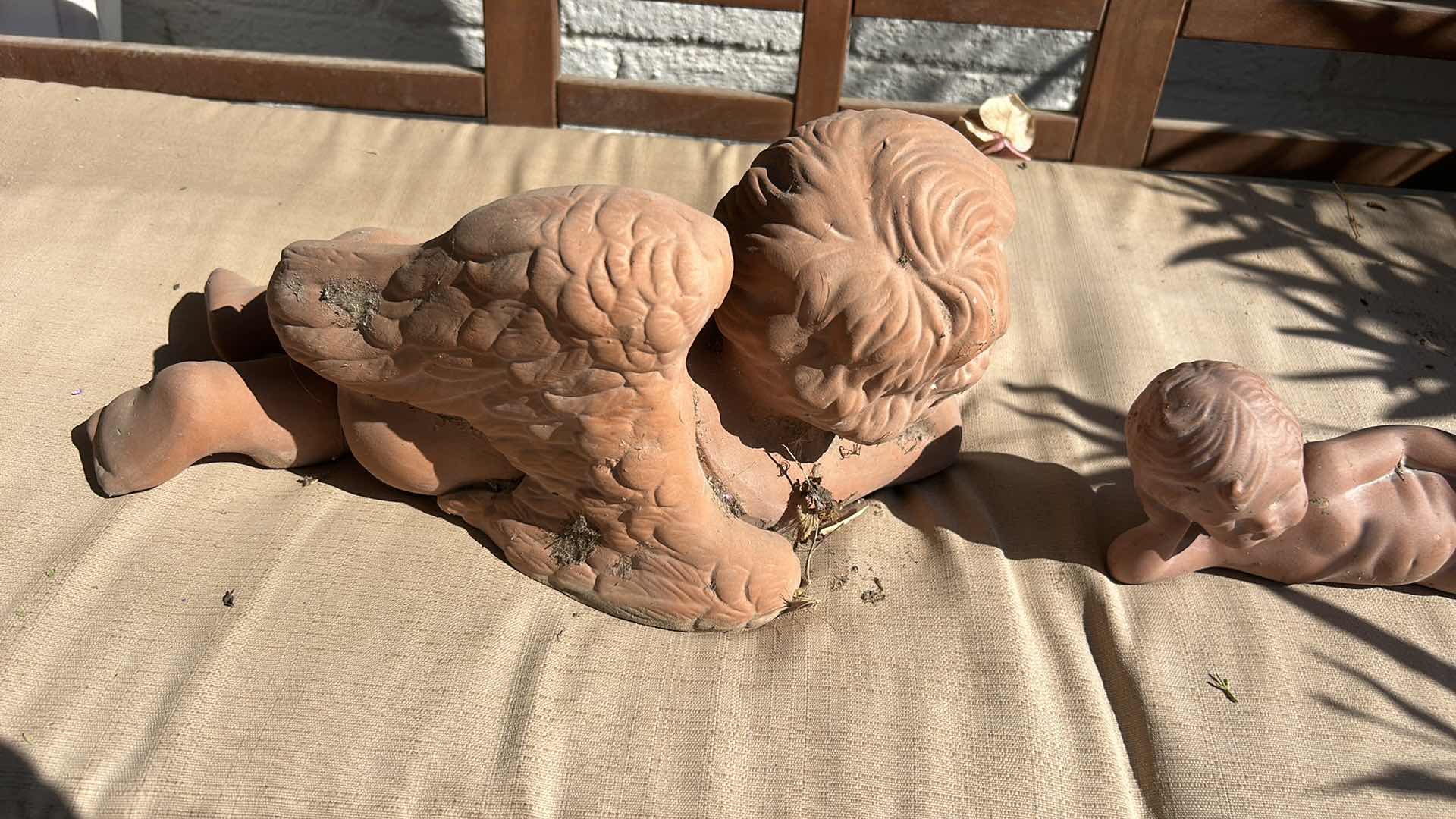 Photo 1 of OUTDOOR DECOR - TWO CERAMIC ANGELS, THE LARGEST, MEASURES 14" X 7".