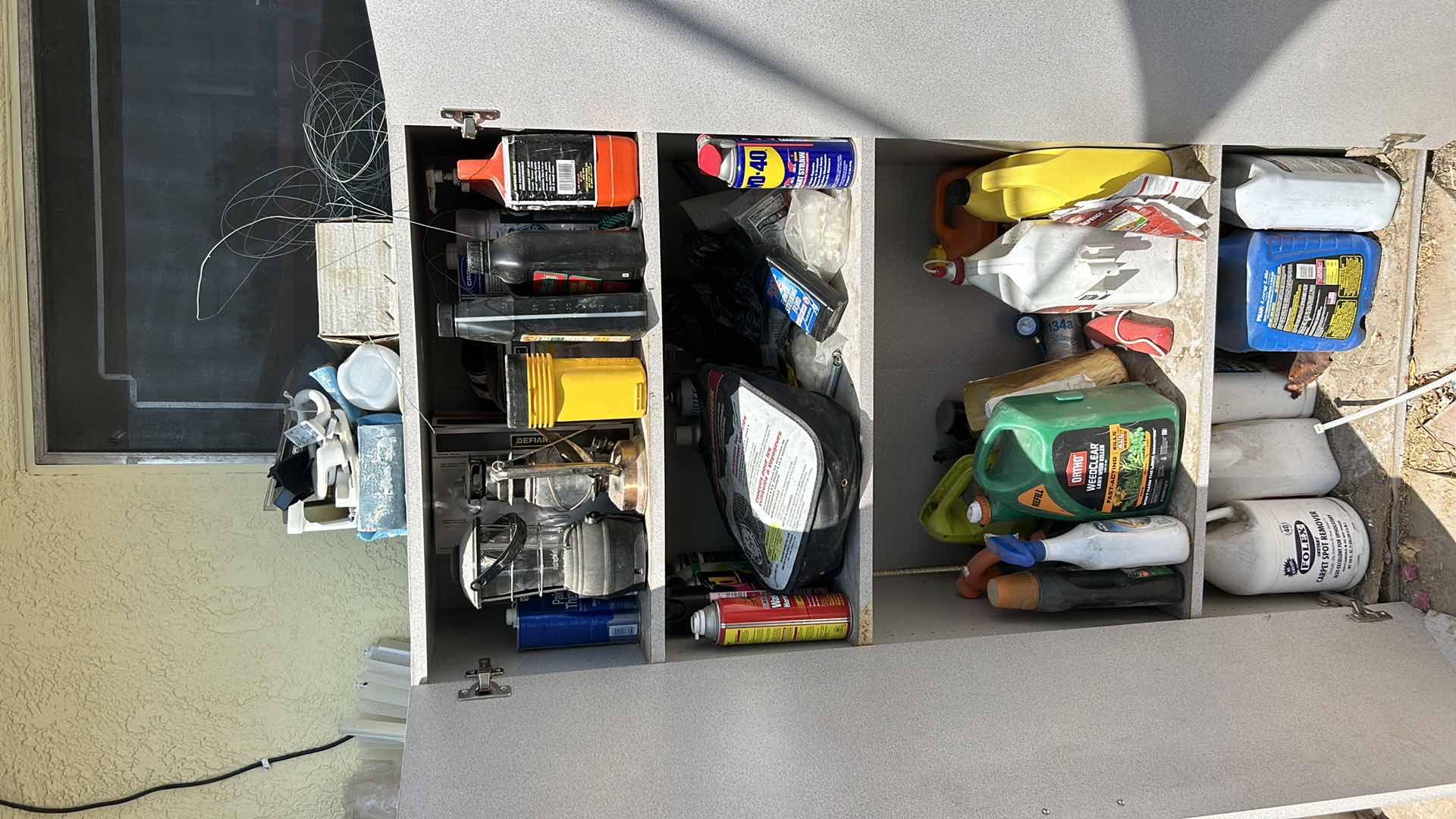 Photo 1 of CONTENTS OF CABINET- LANTERNS, OUTDOOR SUPPLIES , CLEANING SUPPLIES AND MORE