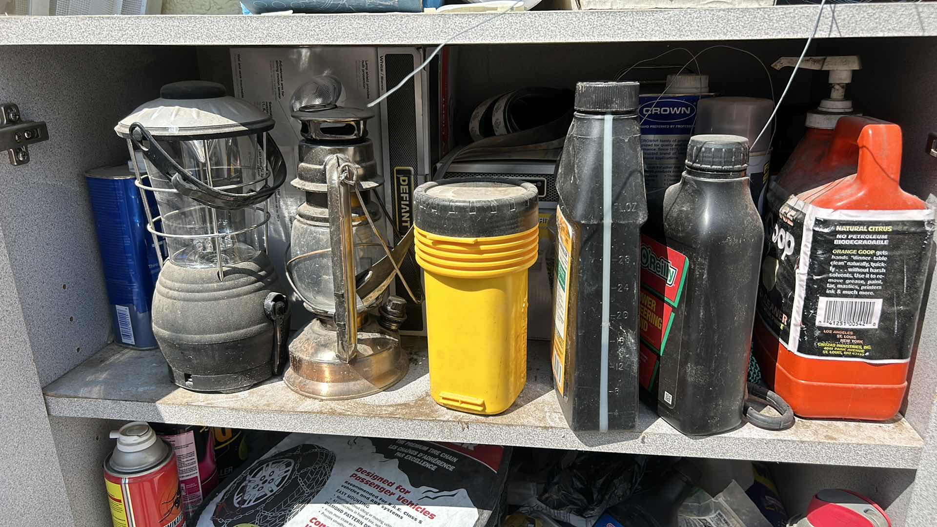 Photo 1 of CONTENTS OF CABINET- LANTERNS, OUTDOOR SUPPLIES , CLEANING SUPPLIES AND MORE