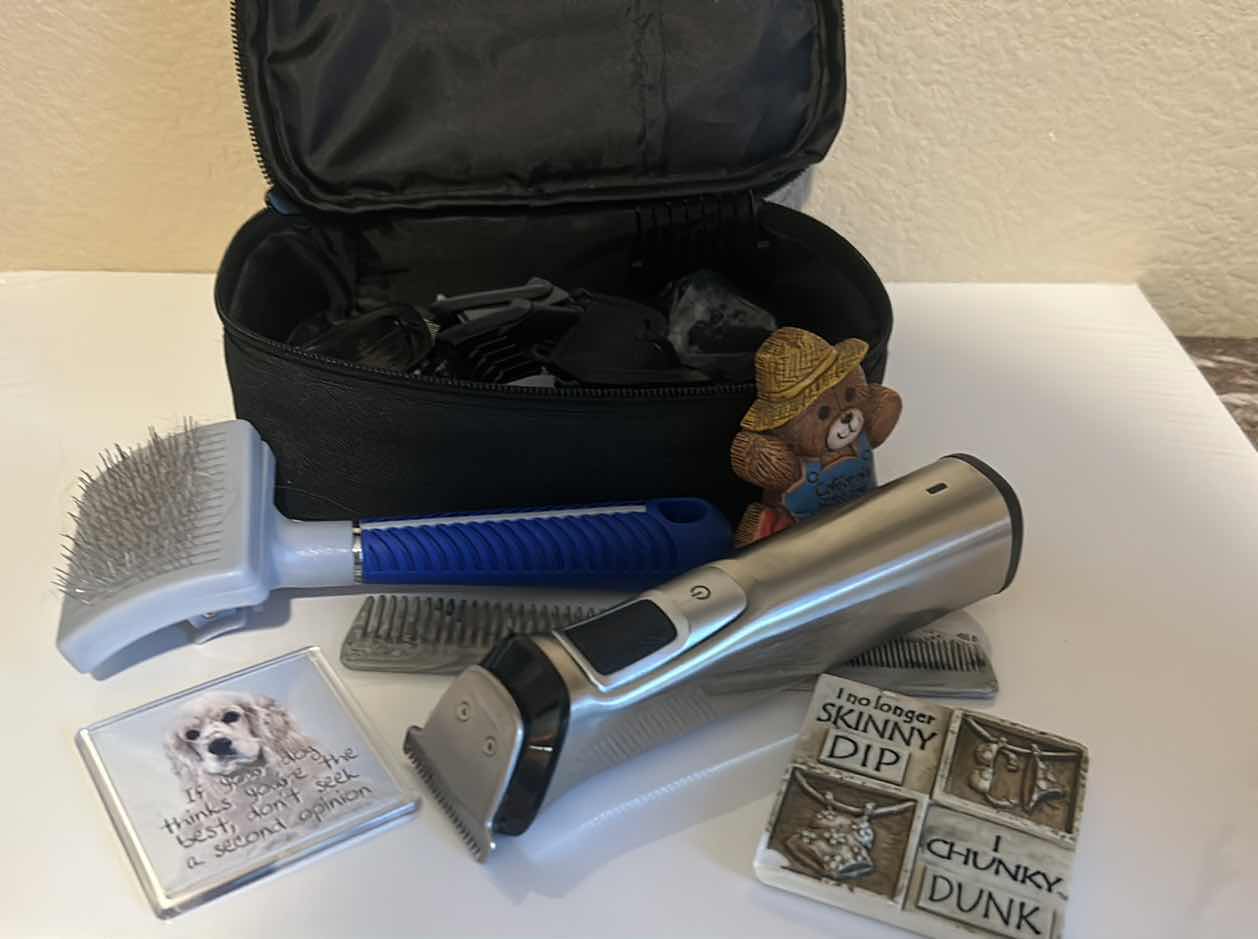 Photo 1 of DOG GROOMING ITEMS WITH CLIPPERS, BRUSHES, AND THREE MAGNETS.