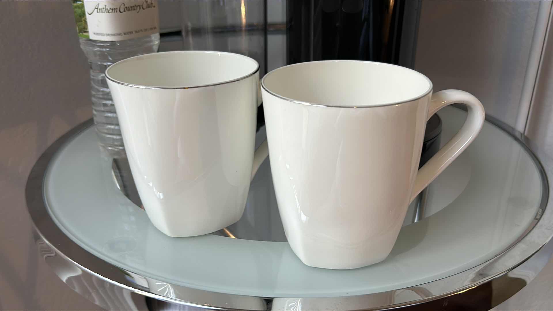 Photo 1 of COFFEE STATION - VERISMO COFFEE MAKER . WELCOME SIGN. TWO BONECHINA COFFEE MUGS BY ROCHERE & ANTHEM COUNTRY CLUB BOTTLED WATER.