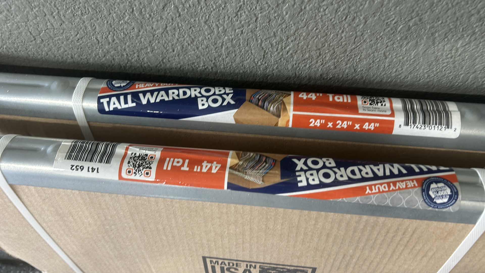 Photo 1 of MOVING AND PACKING MATERIALS, INCLUDING TWO TALL WARDROBE BOXES, GLOVES, AND ACCESSORIES.