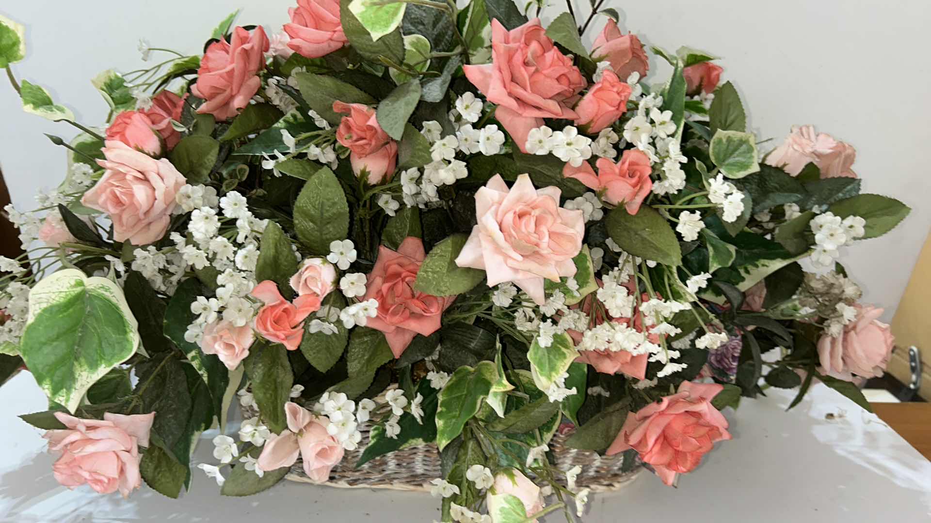 Photo 1 of HOME DECOR, ROSE FAUX FLORAL ARRANGEMENT IN WICKER BASKET, 29” X H16”.
