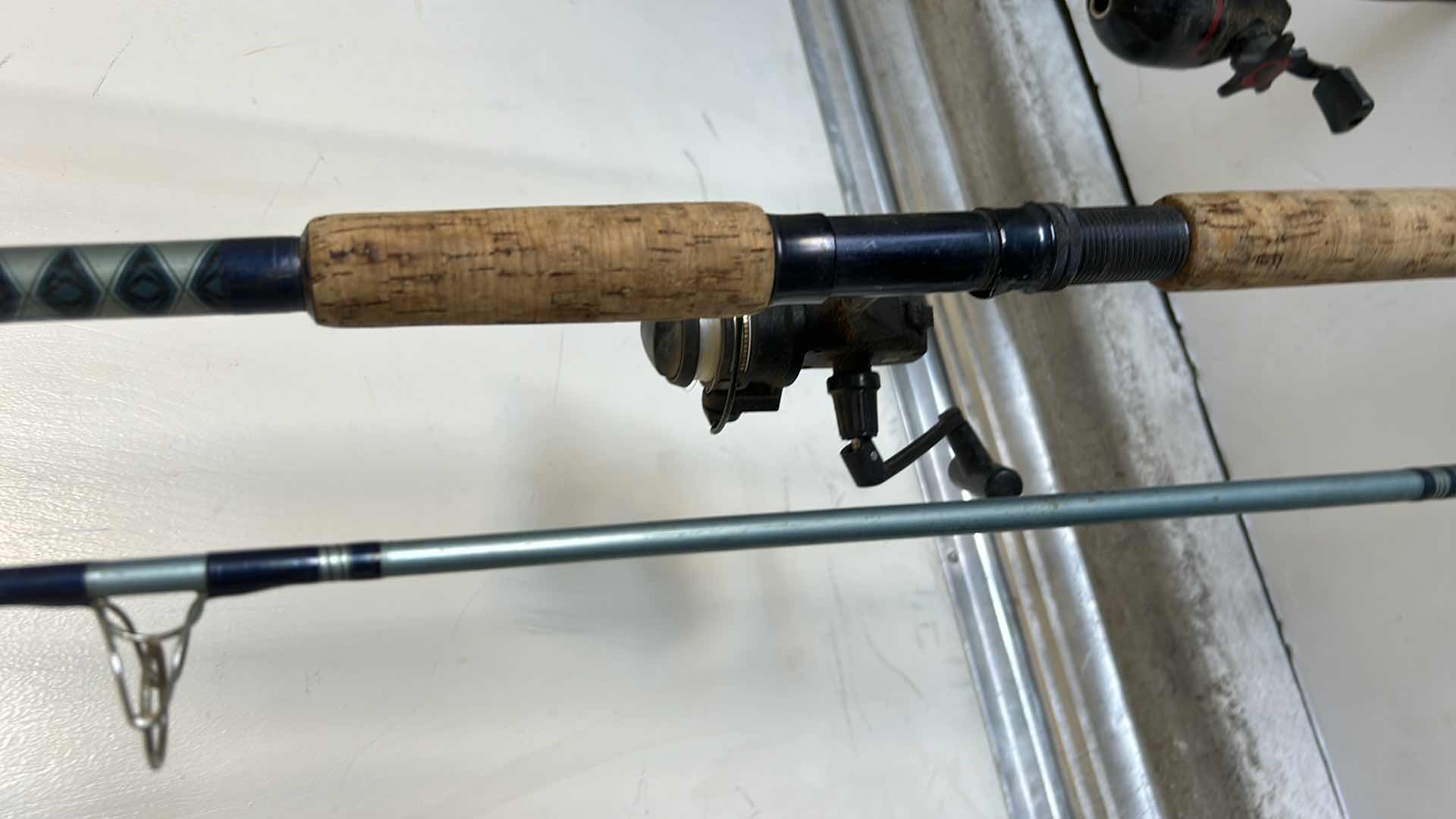 Photo 1 of TWO FISHING RODS AND REELS