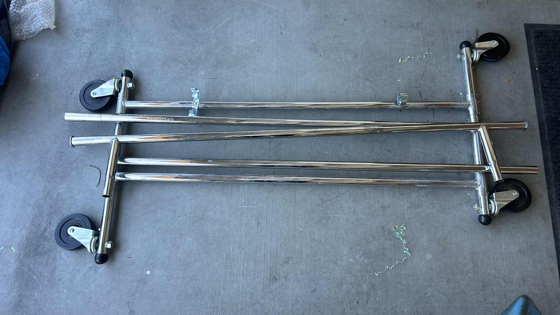 Photo 1 of STURDY, COLLAPSIBLE CLOTHING RACK ON WHEELS.