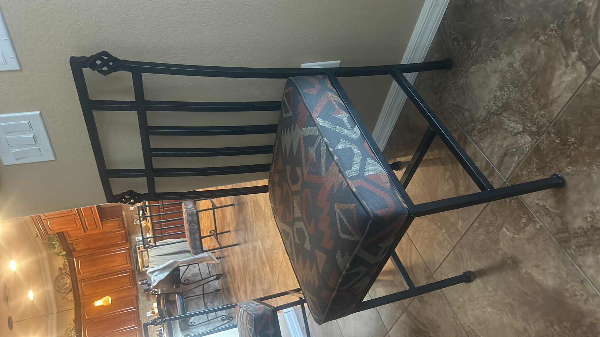 Photo 1 of HEAVY BLACK WROUGHT IRON CHAIR WITH THICK UPHOLSTERED PADDING.