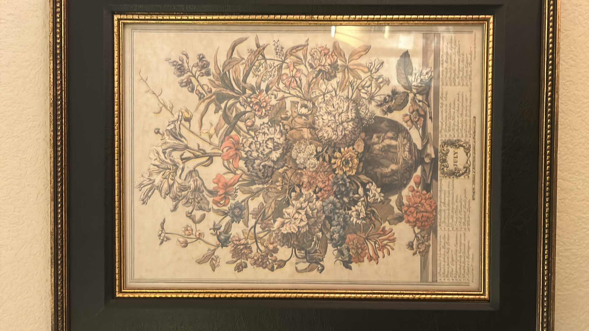Photo 1 of GOLD-FRAMED JULY FLORAL ARTWORK, 17.5” X H 21.5”.
