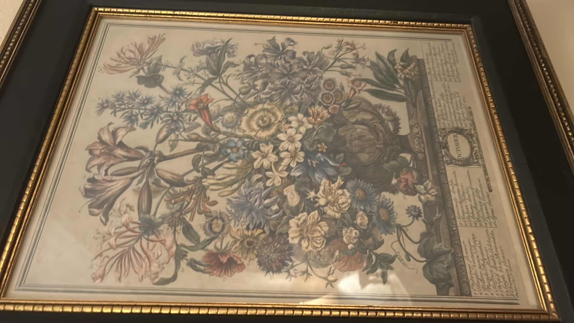 Photo 1 of GOLD-FRAMED OCTOBER FLORAL ARTWORK, 17.5” X H 21.5”.