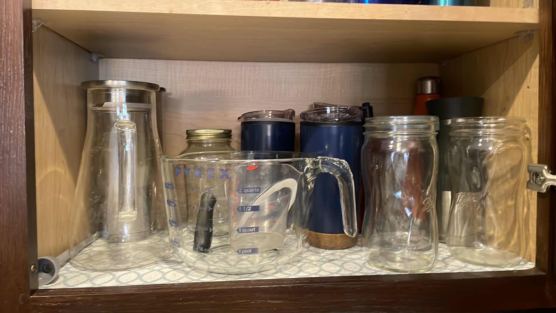 Photo 1 of CONTENTS OF CABINET - TRAVEL AND MEASURING CUPS