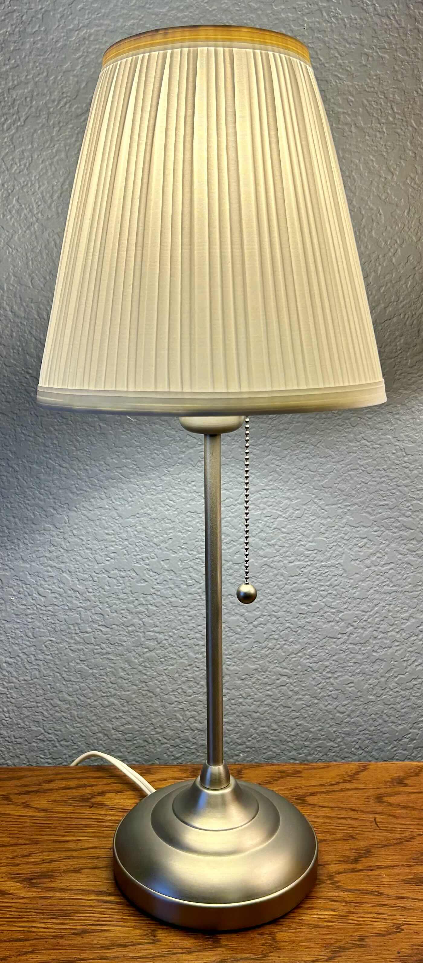 Photo 1 of PAIR OF LAMPS: SILVER LAMP 22”: THREE WAY SWITCH WOODEN LAMP 26”