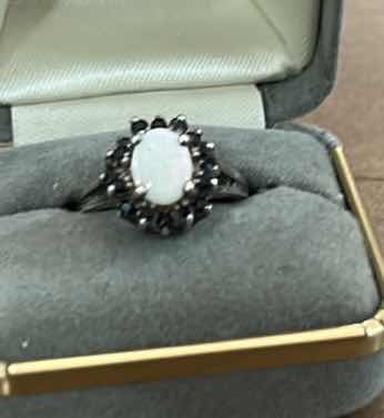 Photo 1 of STAMPED .925 STERLING SILVER RING WITH OPAL AND RED GEMSTONES EST SIZE 6