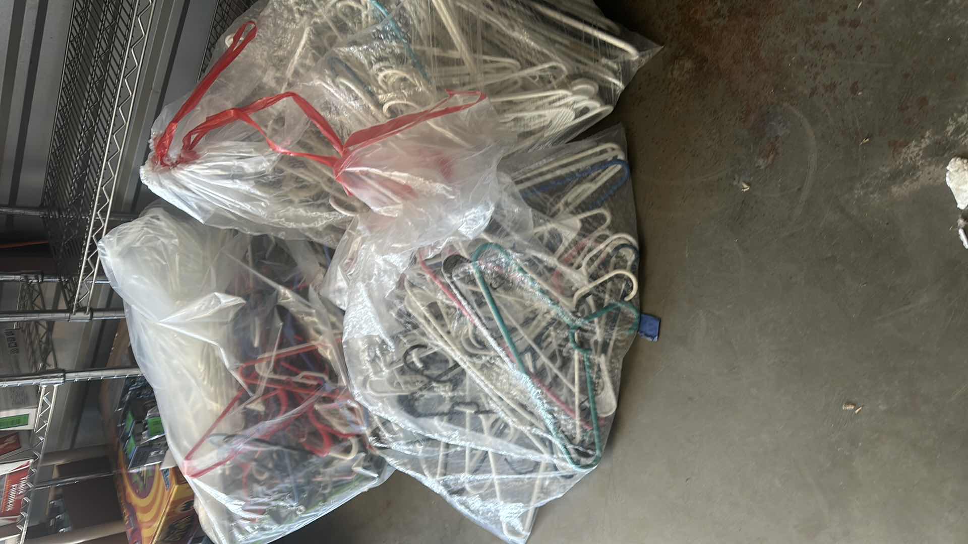 Photo 1 of BAGS OF PLASTIC HANGERS