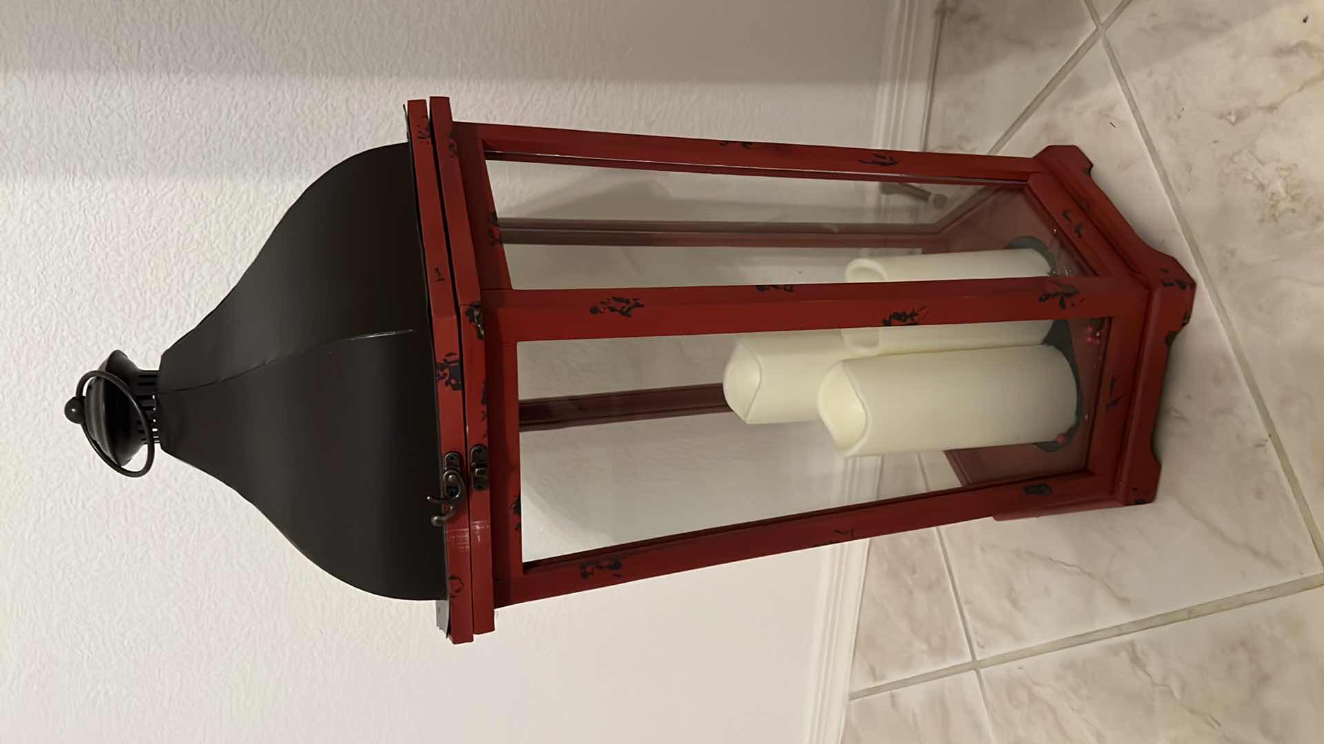 Photo 1 of KIRKLAND TALL LANTERN RED W BLACK TOP & 3-BATTERY OPERATED CANDLES H30"