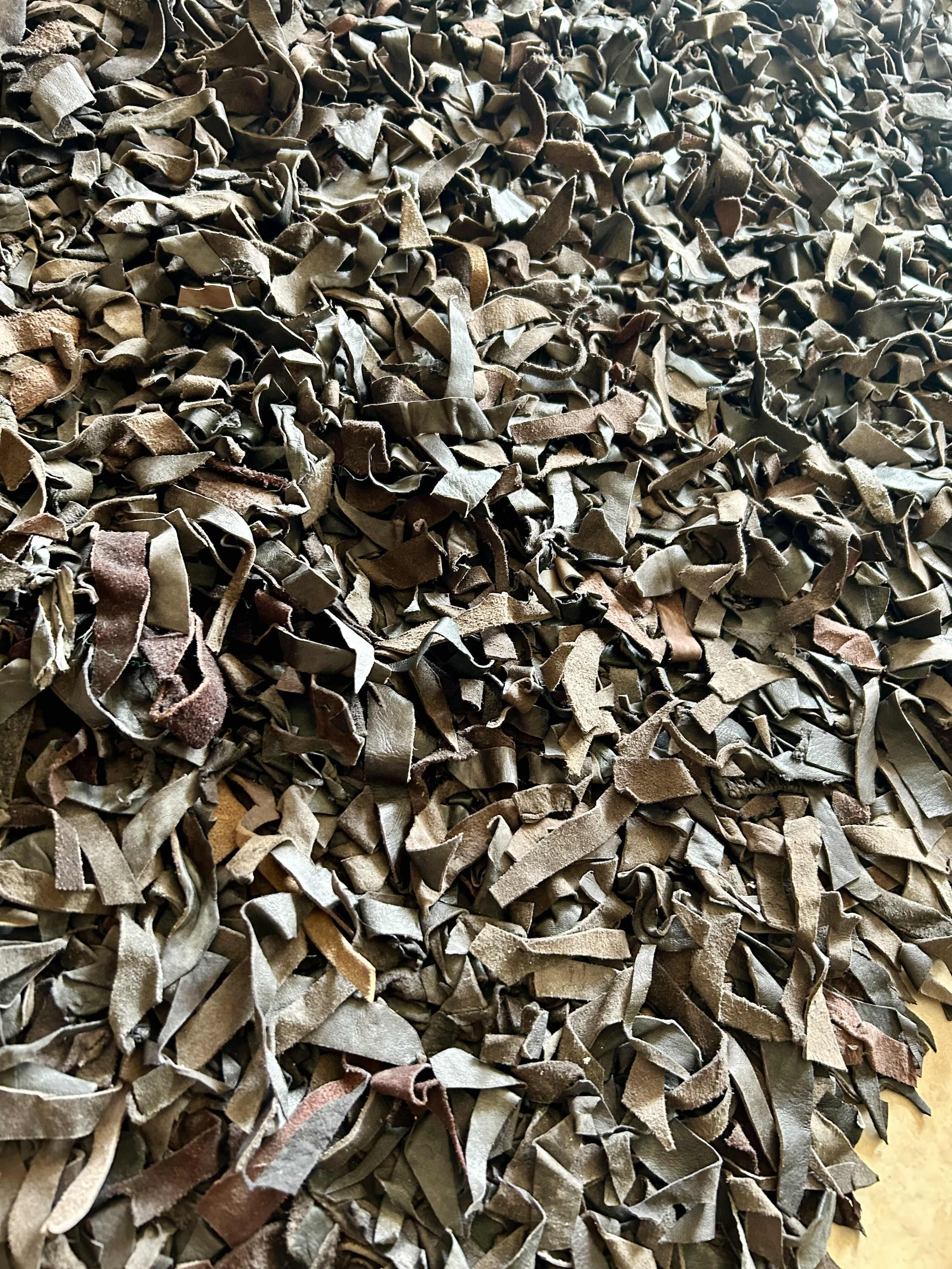 Photo 1 of 30” X 51” VARIEGATED BROWN  LEATHER SHAG RUG 
RETAIL: $200.00