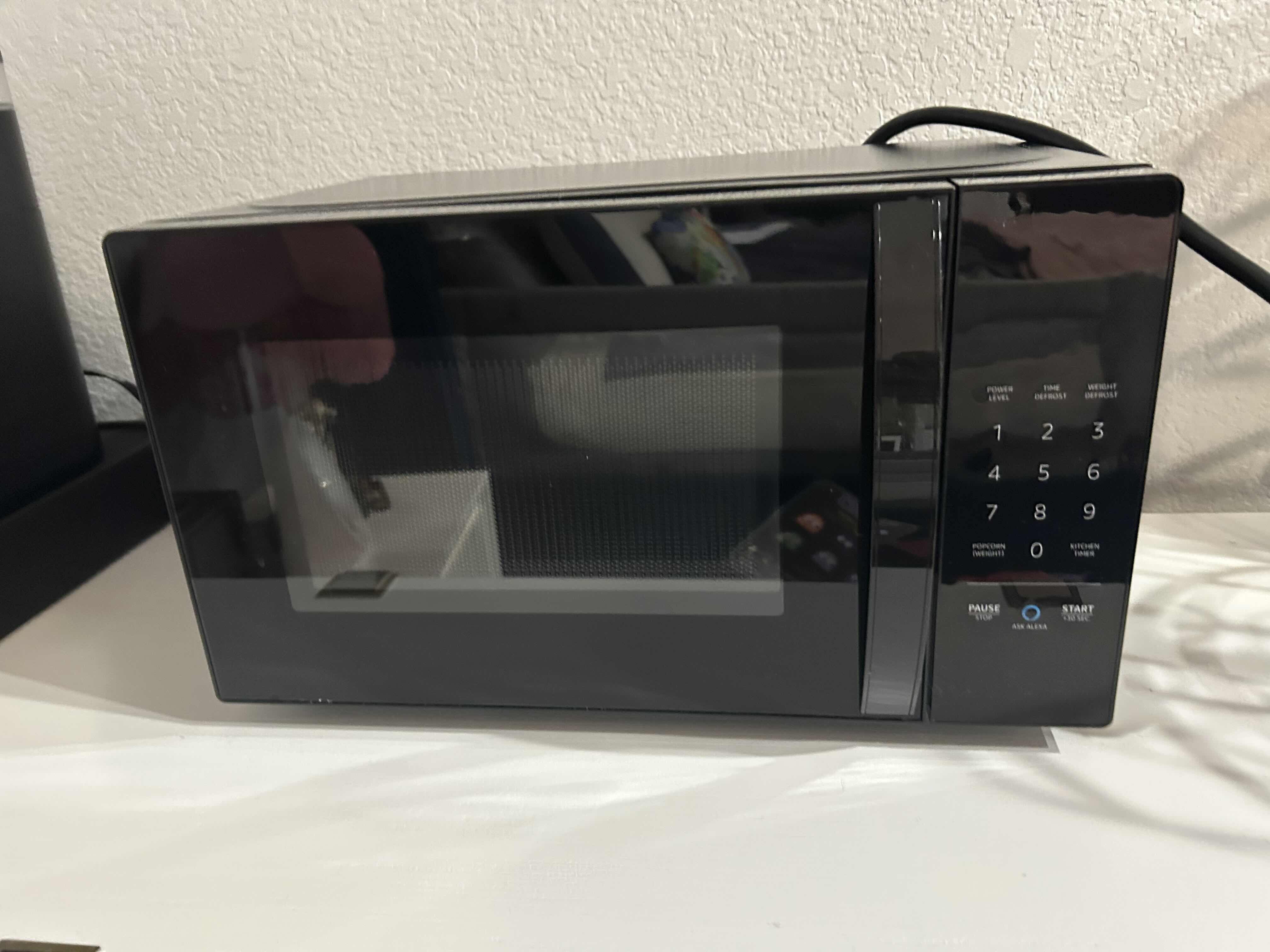 Photo 1 of AMAZONBASICS BLACK COUNTER TOP MICROWAVE - WORKS WITH ALEXA