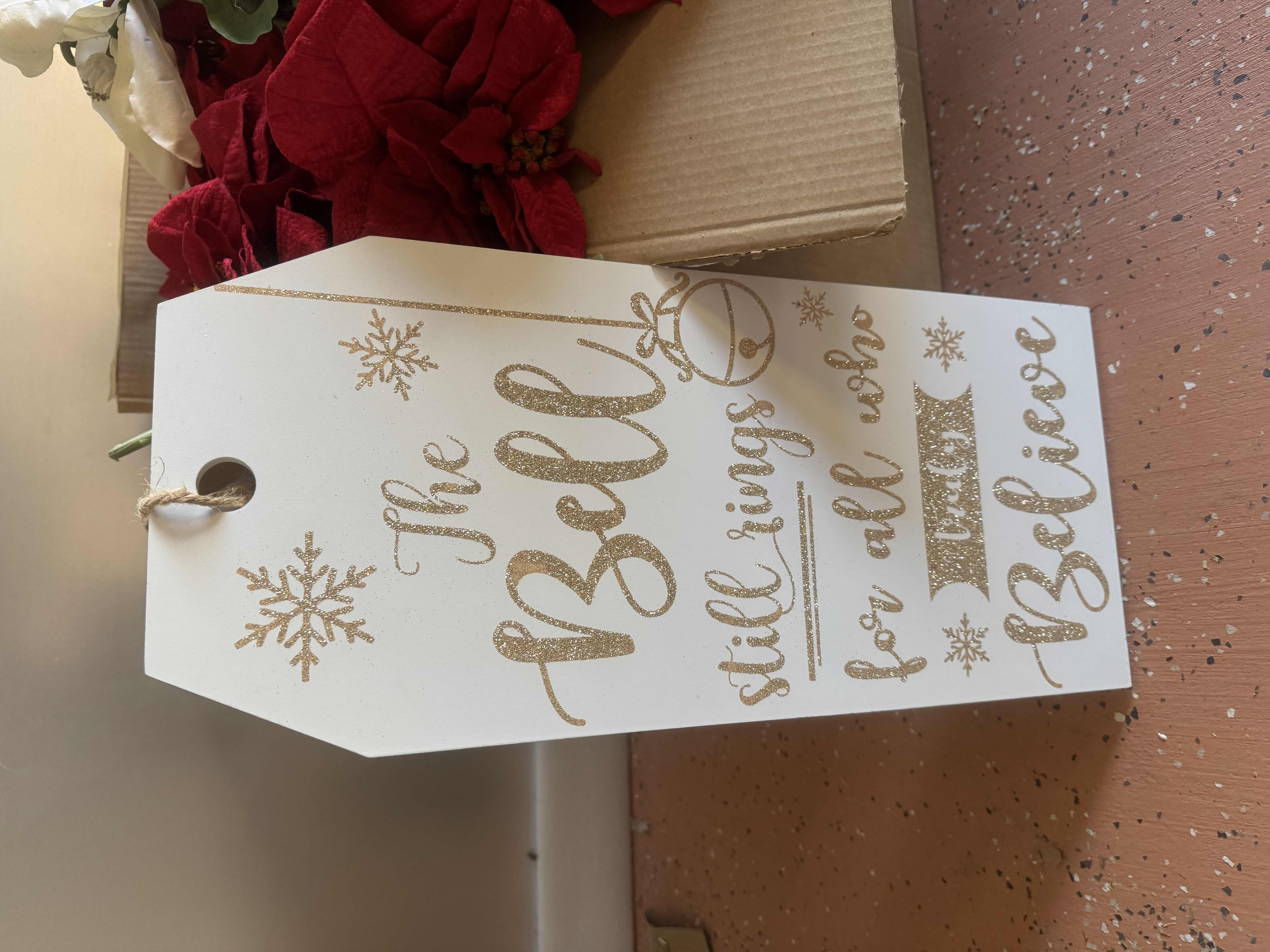 Photo 1 of BOX OF POINSETTIAS AND ONE HOLIDAY SIGN 9” X 20”