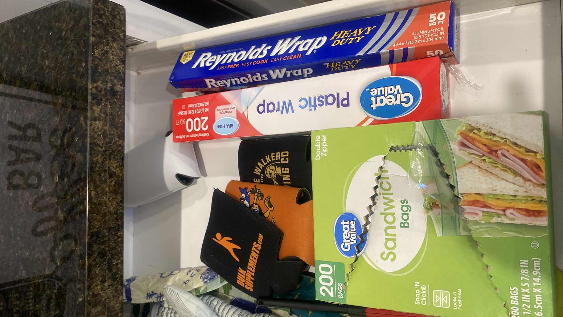 Photo 1 of CONTENTS OF KITCHEN CABINET WRAPPINGS & LINENS