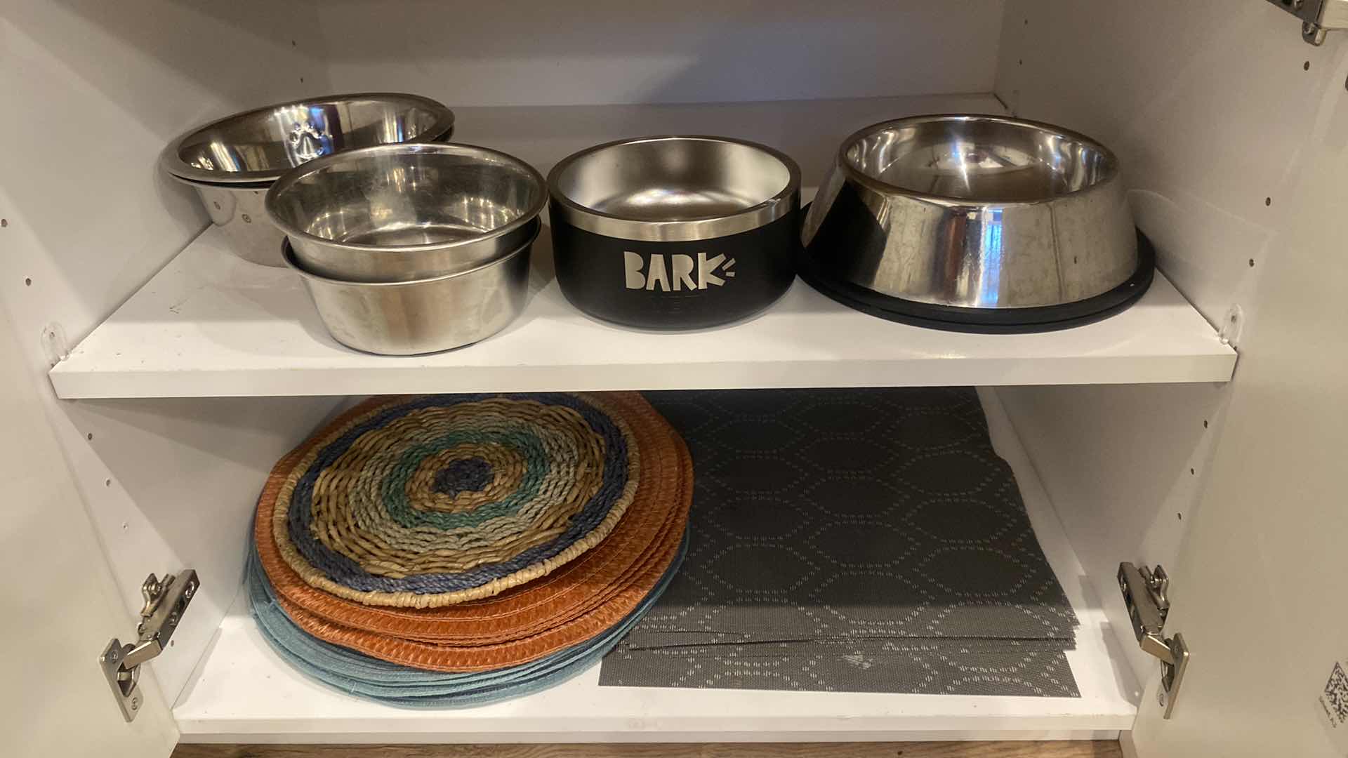 Photo 1 of CONTENTS OF KITCHEN CABINET DOG BOWLS & PLACEMATS