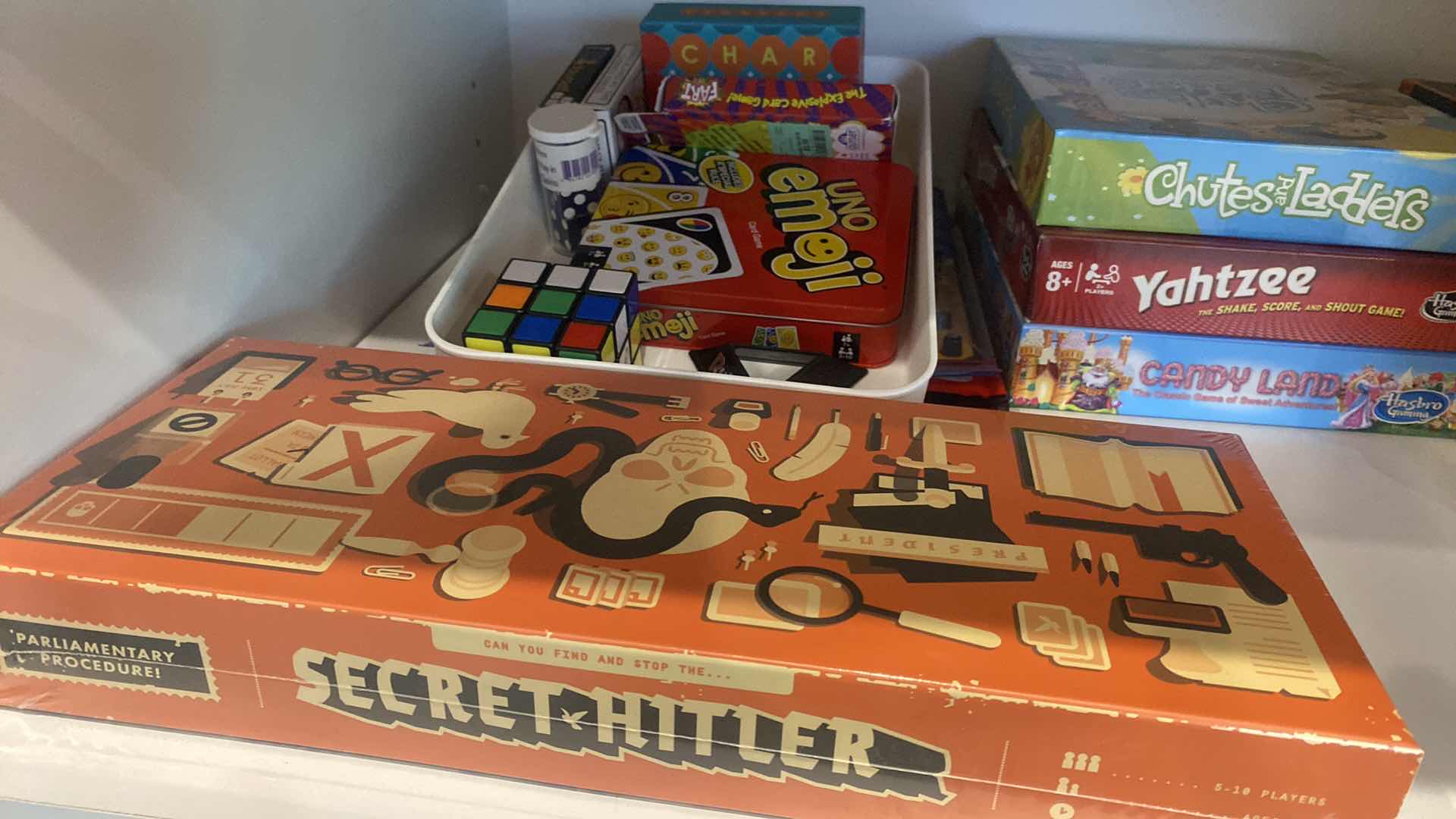 Photo 1 of CONTENTS OF KITCHEN CABINET ASSORTED GAMES