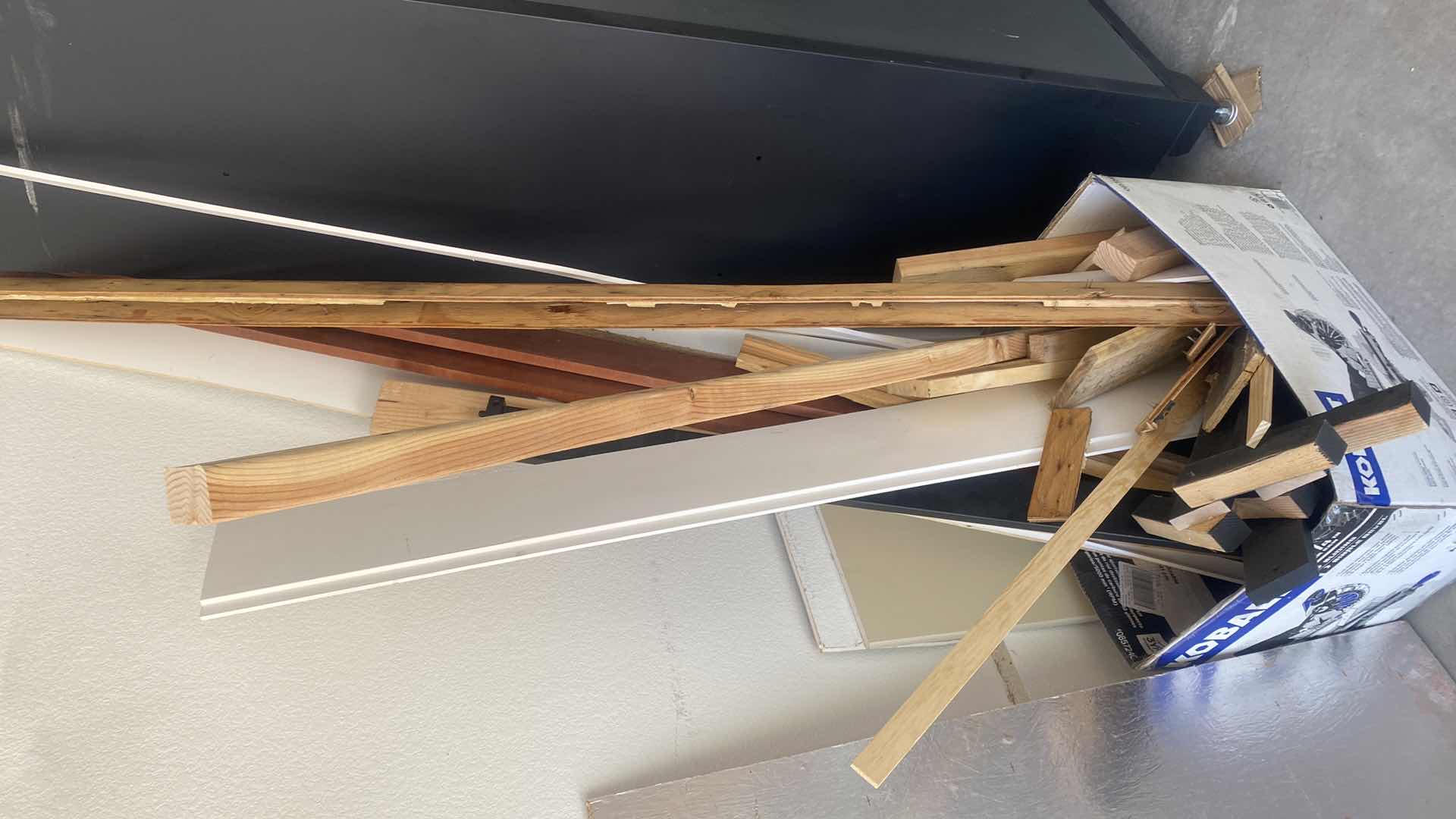 Photo 1 of CARDBOARD BOX OF ASSORTED WOOD IN GARAGE