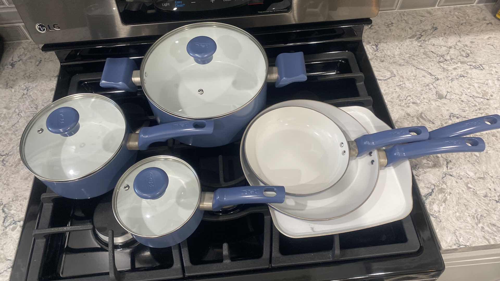 Photo 1 of CONTENTS KITCHEN CABINET - 9 PIECE T-FAL POTS & PANS