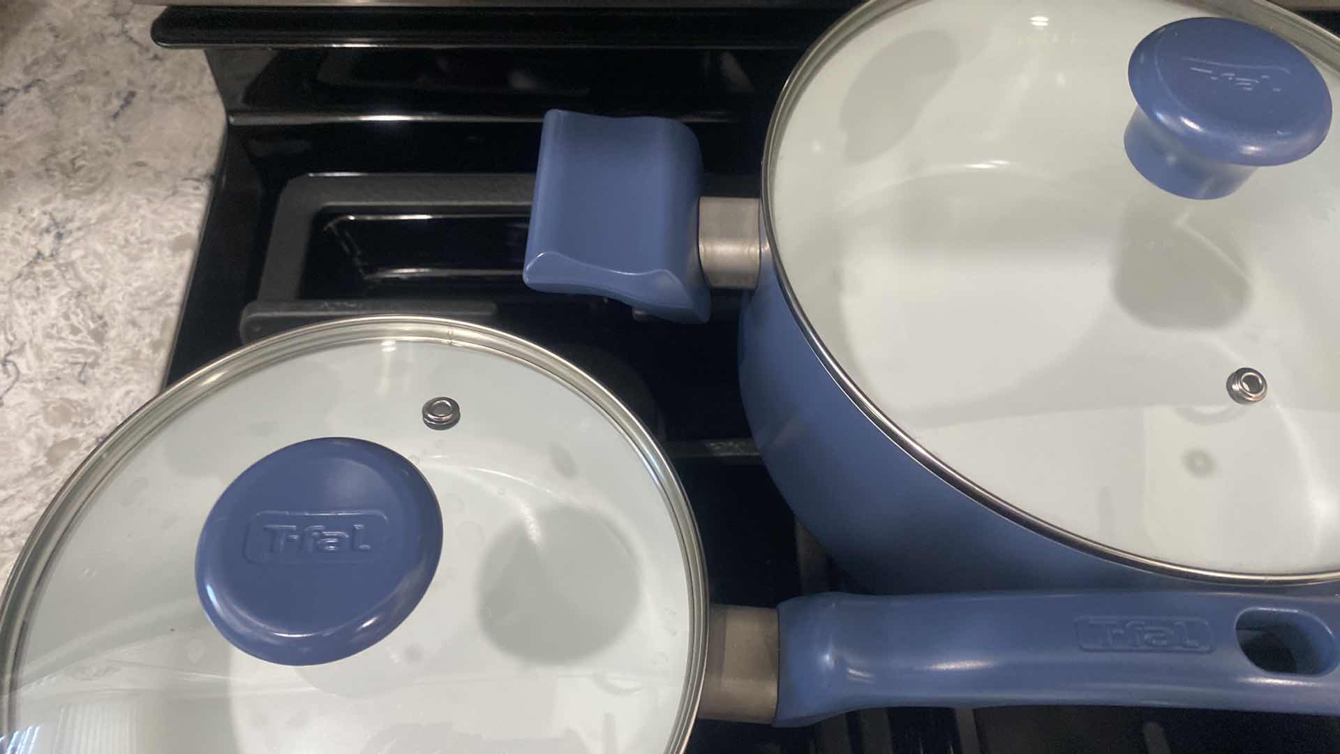 Photo 1 of CONTENTS KITCHEN CABINET - 9 PIECE T-FAL POTS & PANS