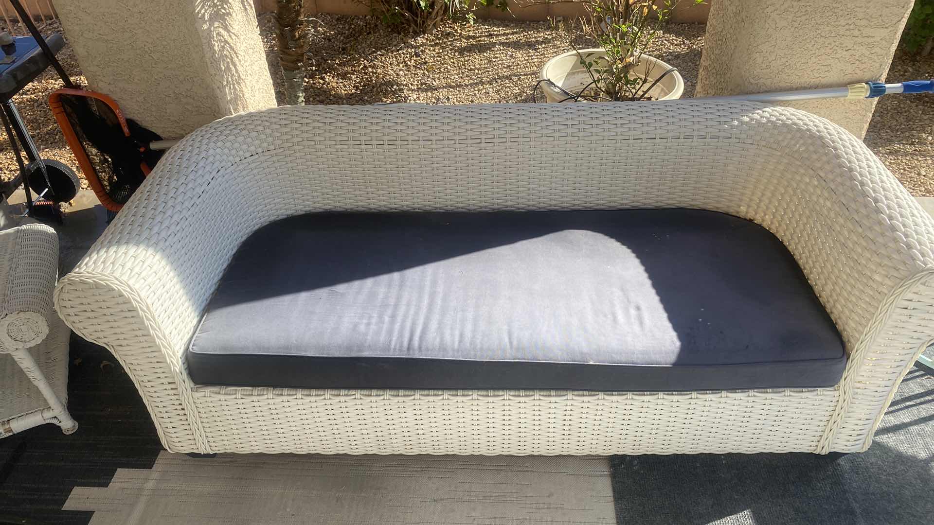 Photo 1 of PLASTIC WICKER OUTDOOR SOFA WITH FADED BLACK CUSHION 80” x 33“ H 27”