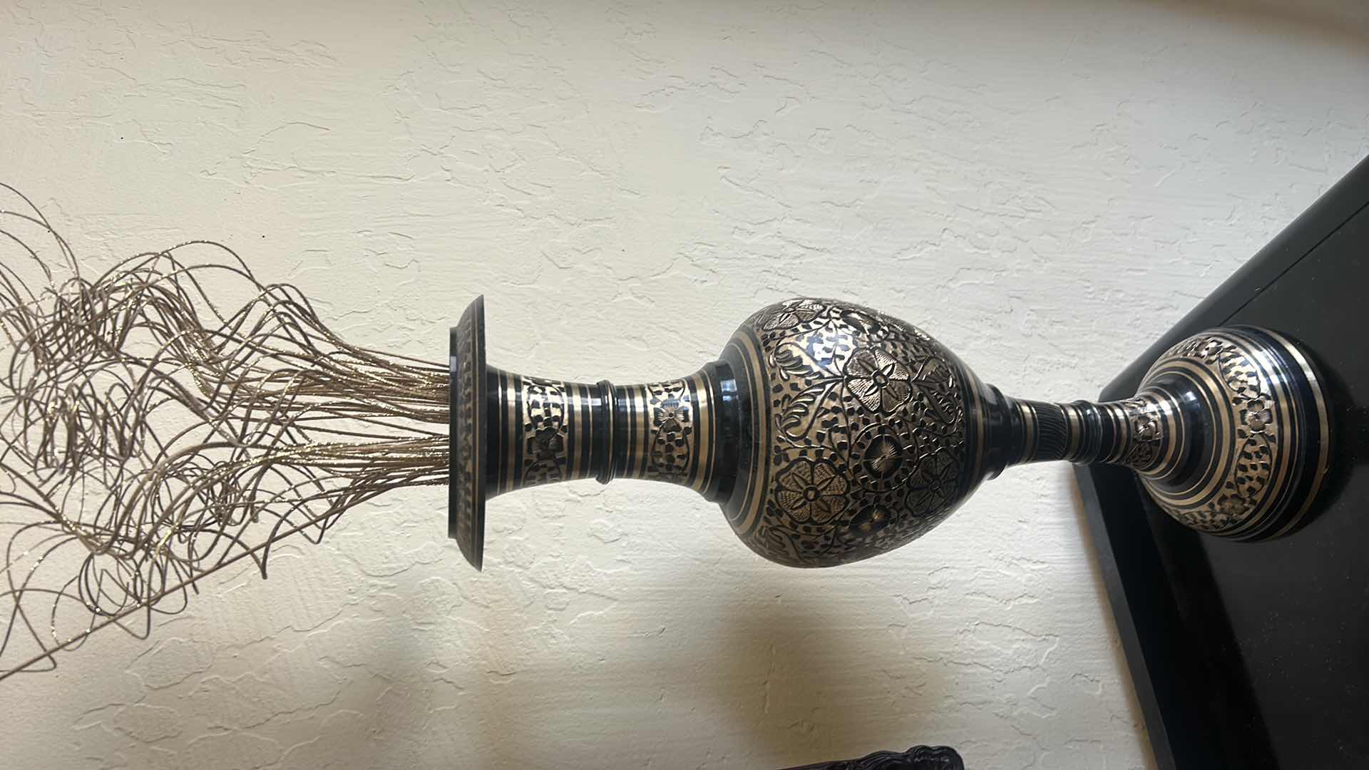 Photo 1 of BLACK AND GOLD METAL VASE, H 20.5”, WITH GOLD REEDS.
