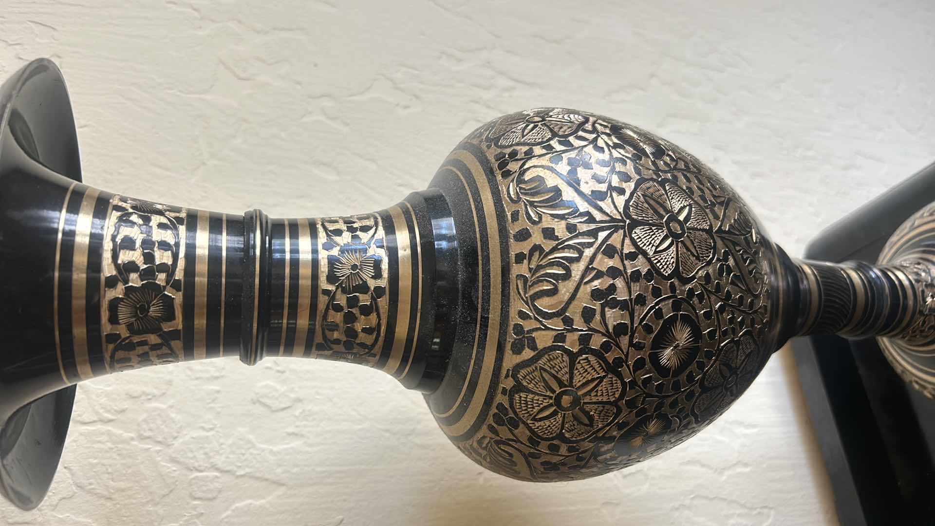 Photo 1 of BLACK AND GOLD METAL VASE, H 20.5”, WITH GOLD REEDS.