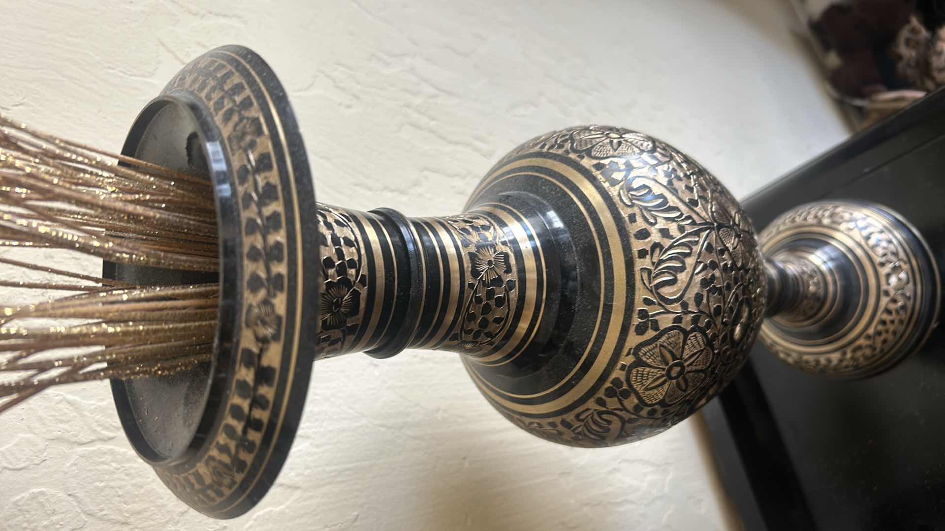 Photo 1 of BLACK AND GOLD METAL VASE, H 20.5”, WITH GOLD REEDS.