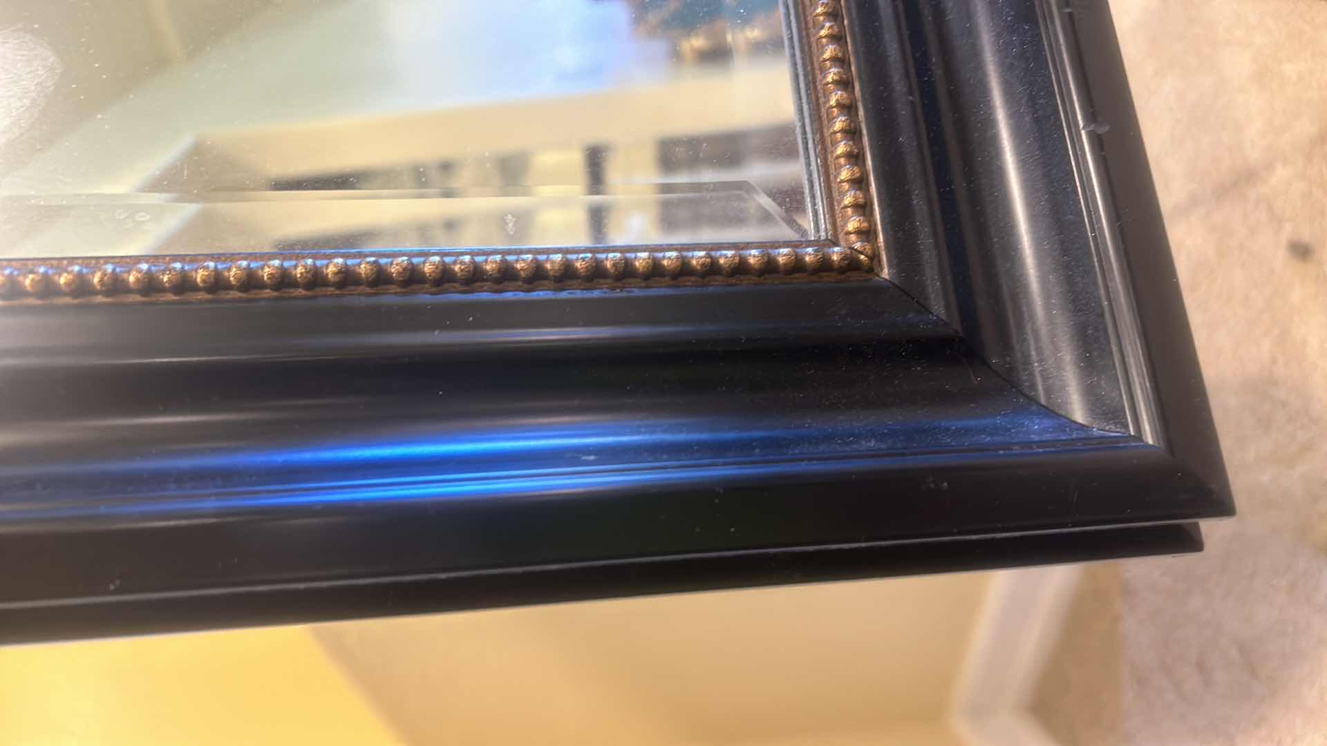 Photo 1 of BLACK FRAMED BEVELED GLASS MIRROR WITH GOLD ROPING 28” X H 33”.