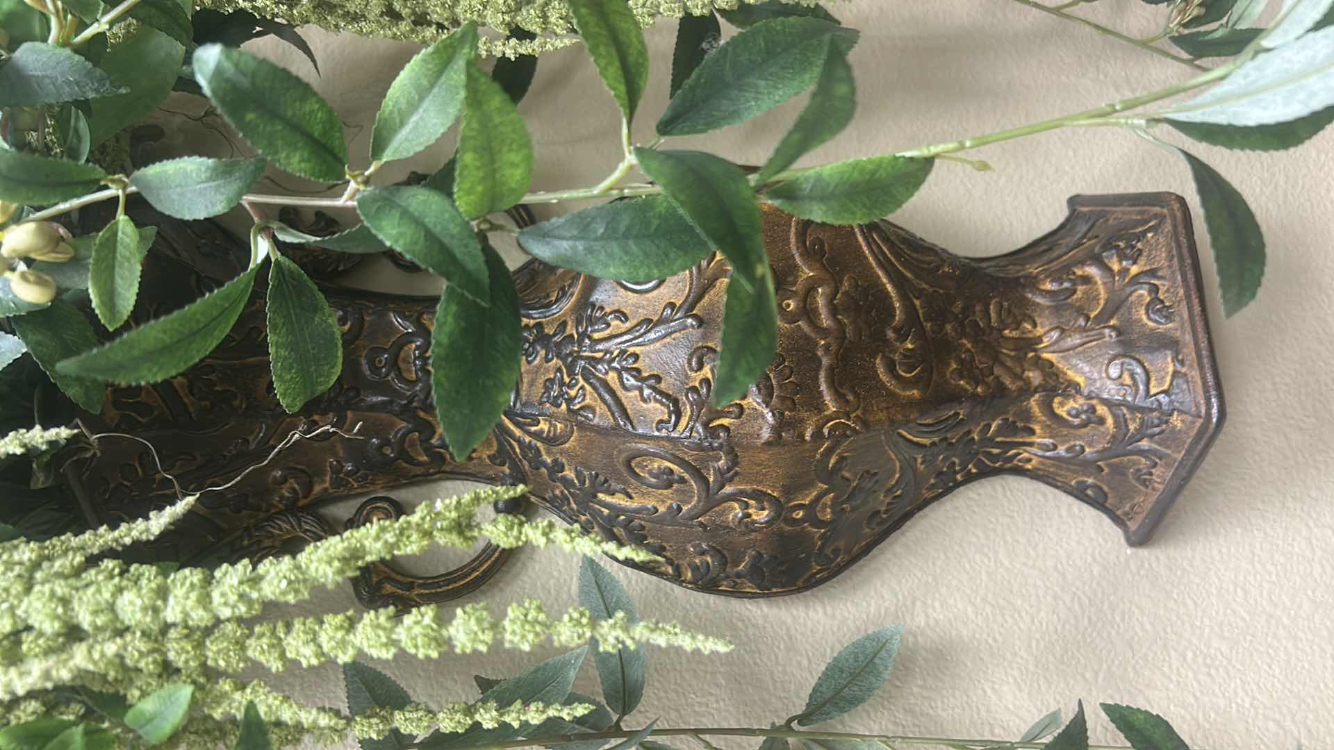 Photo 1 of WALL-MOUNTED BRONZE-FINISH METAL VASE WITH ARTIFICIAL GREEN FOILAGE AND HANGING AMARANTHUS SPRAY H26”