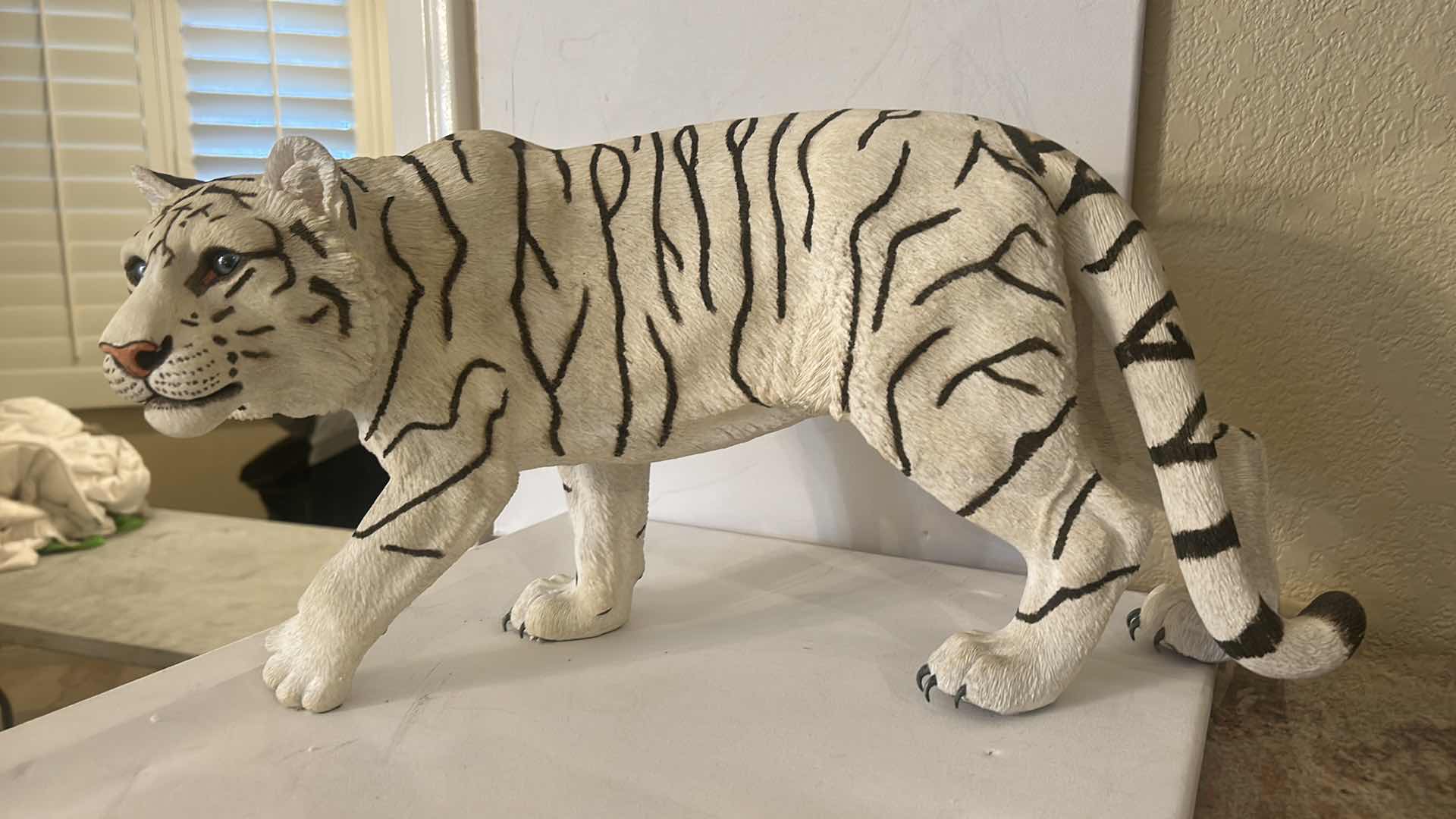 Photo 1 of RESIN WHITE TIGER FIGURINE, REALISTIC WILDLIFE SCULPTURE, HAND-PAINTED SAFARI DECOR, STATEMENT ANIMAL ACCENT PIECE. 20” x H10”