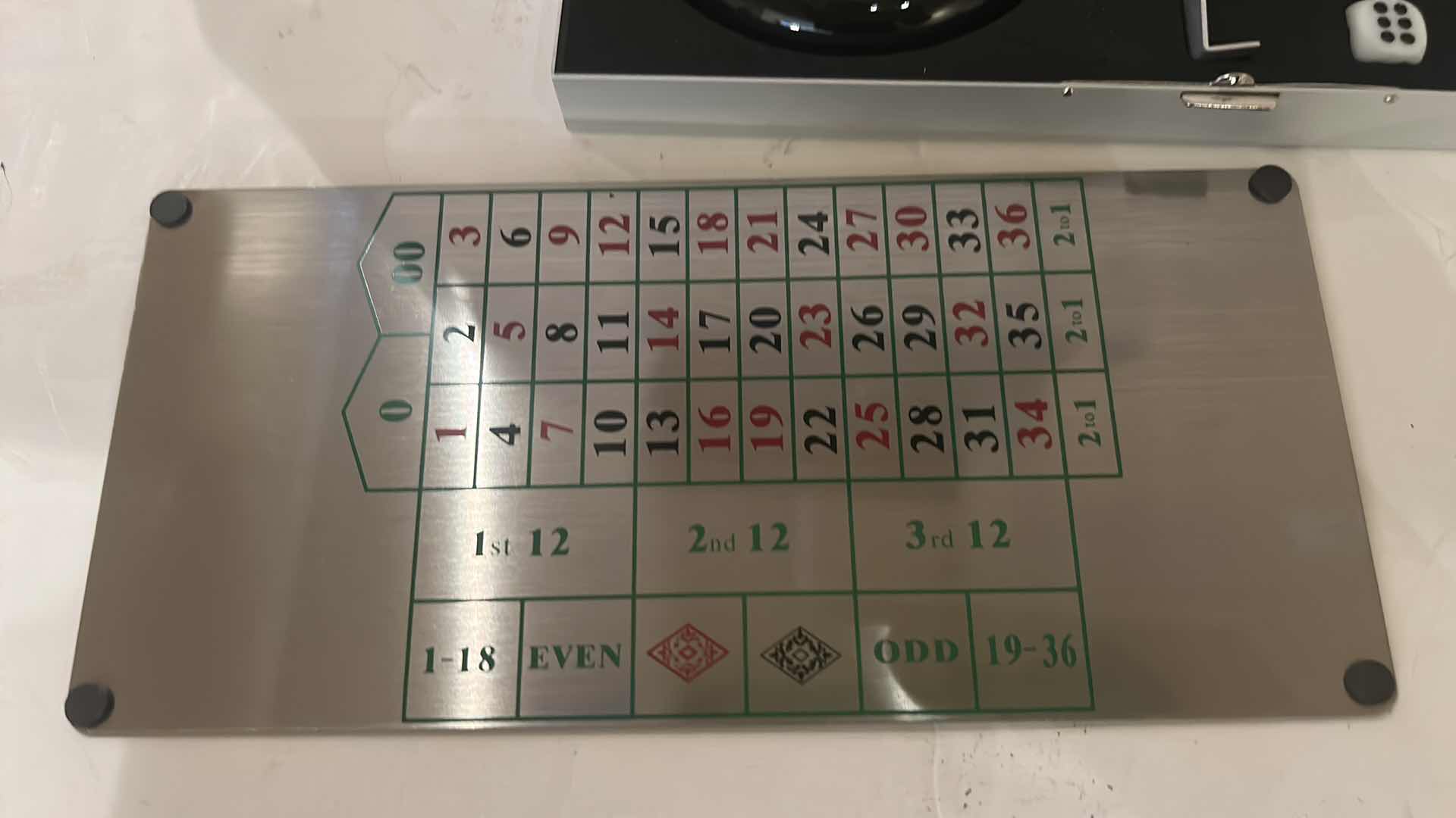 Photo 1 of MINIATURE GAMBLING SET IN METAL BOX, INCLUDING ROULETTE, CRAPS, AND BLACKJACK. 9” x H4 1/4”