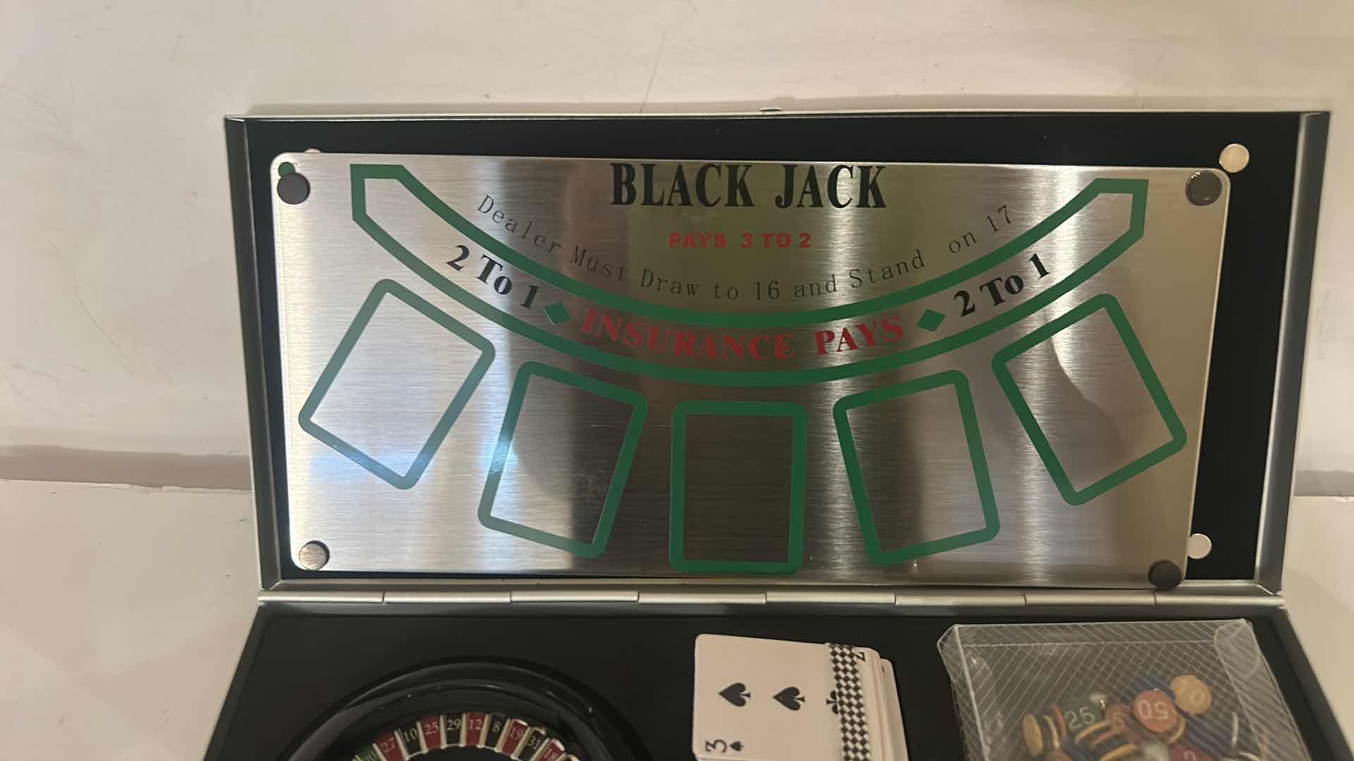 Photo 1 of MINIATURE GAMBLING SET IN METAL BOX, INCLUDING ROULETTE, CRAPS, AND BLACKJACK. 9” x H4 1/4”