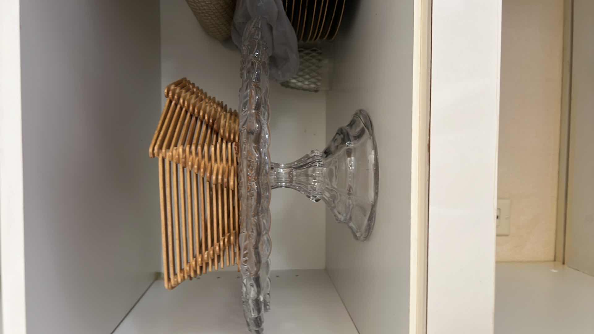 Photo 1 of CONTENTS OF KITCHEN CABINET- CAKE STAND, CHARGERS, PLACEMATS